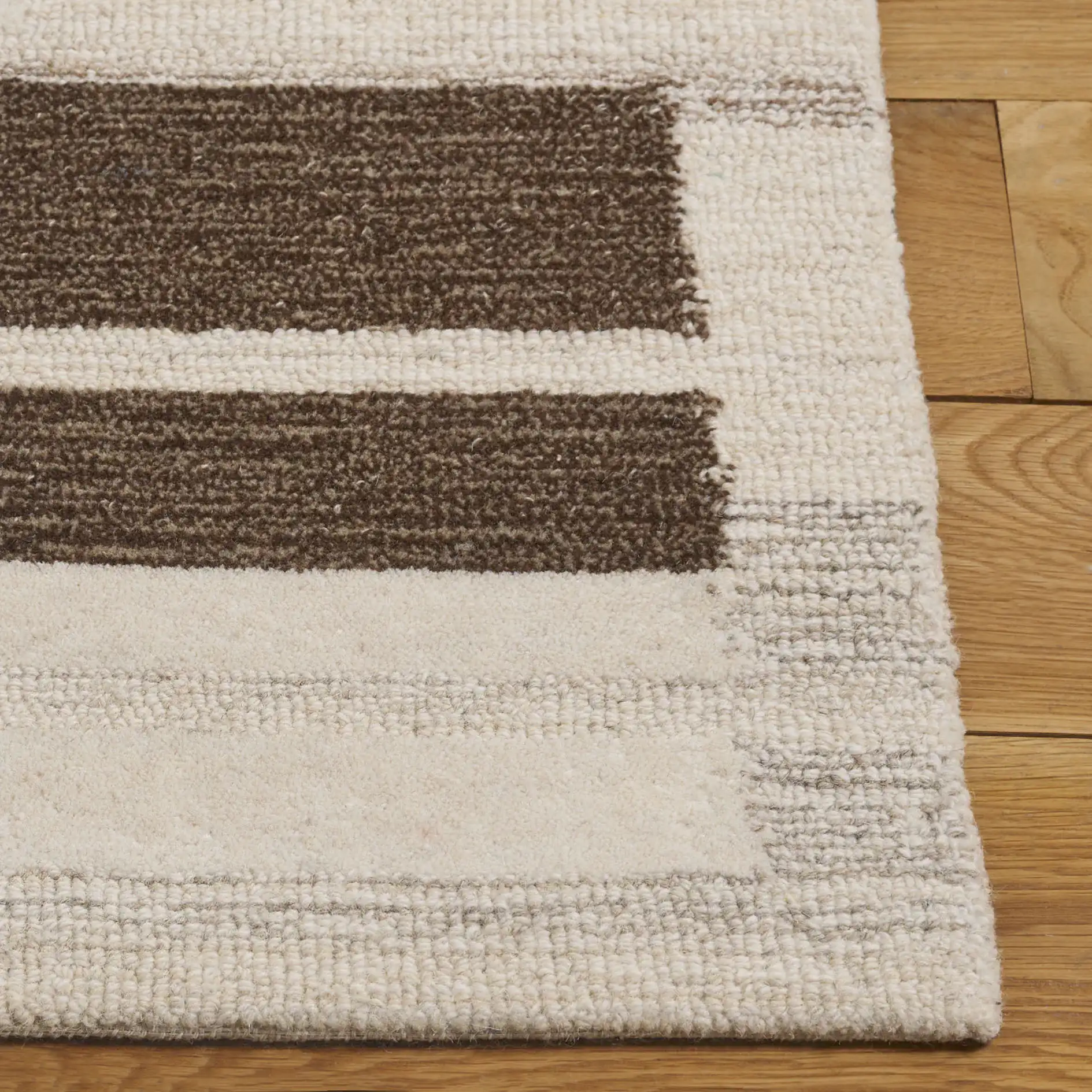 Ebony Stepped Geometric Hand-Tufted Wool Rug in Brown / Ivory in a styled room