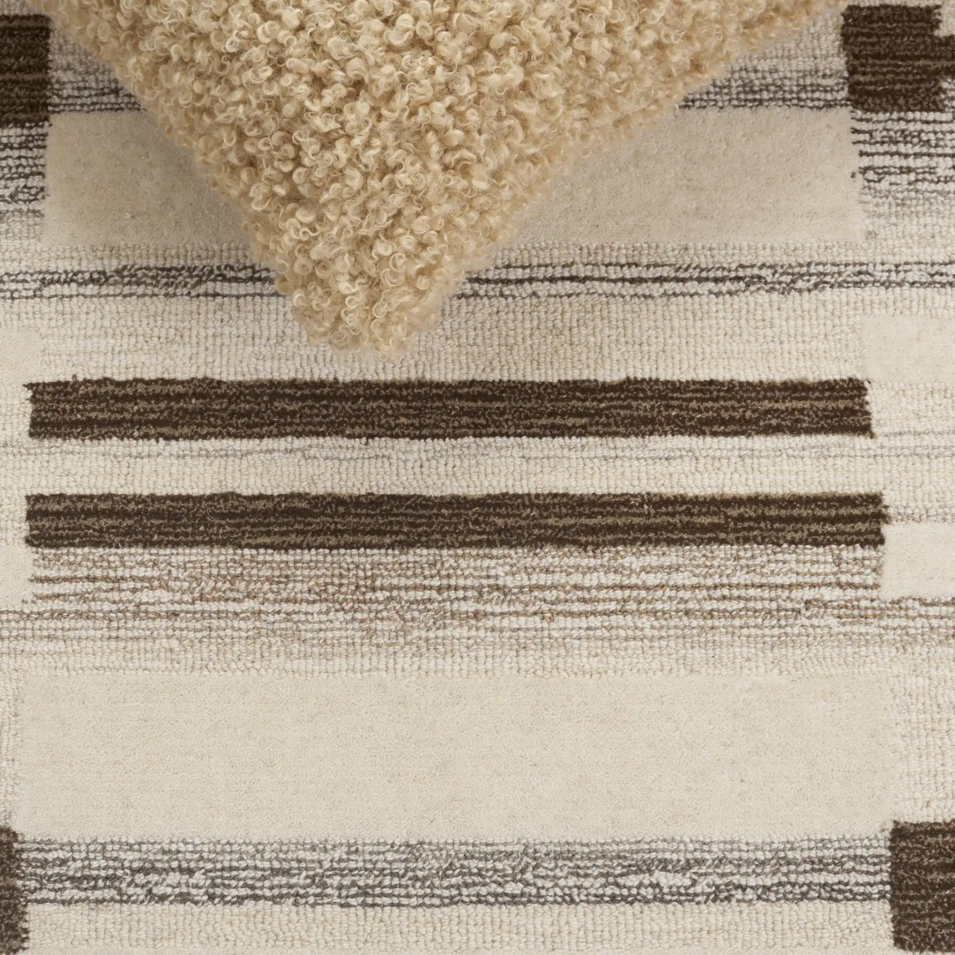 Ebony Stepped Geometric Hand-Tufted Wool Rug in Brown / Ivory in a styled room