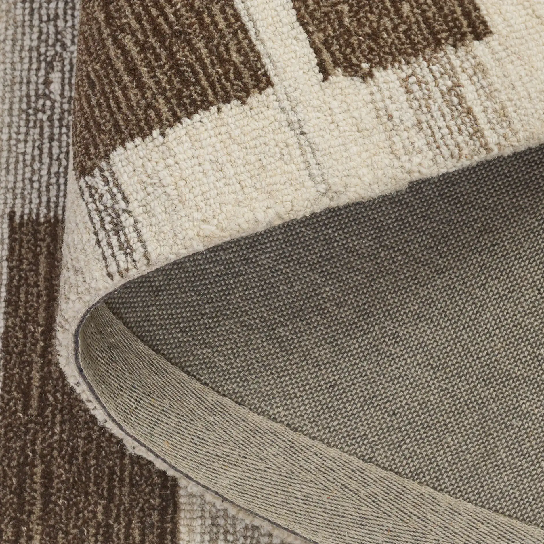 Ebony Stepped Geometric Hand-Tufted Wool Rug in Brown / Ivory in a styled room