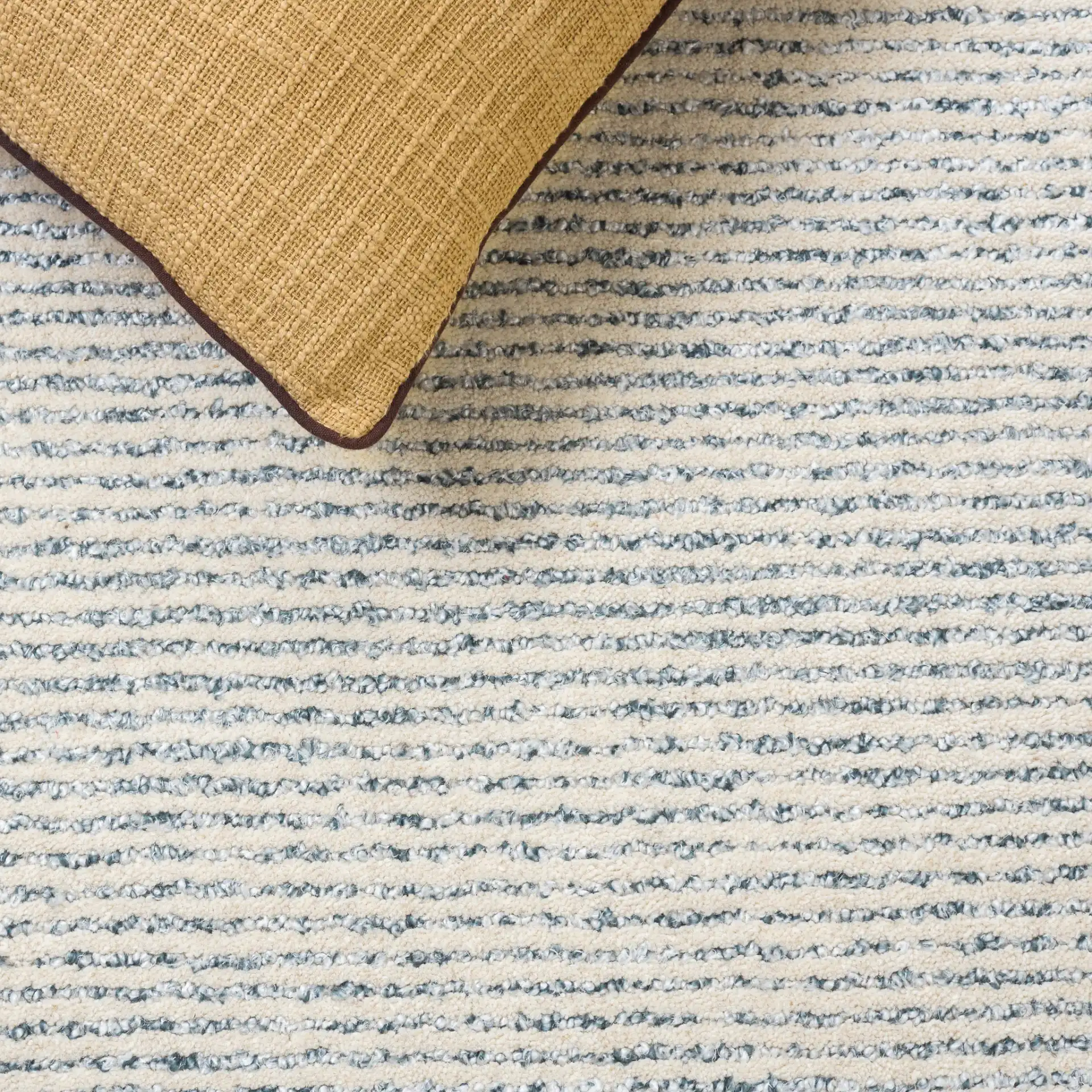 Ebony Striped Hand-Tufted Rug in Gray / Ivory in a styled room