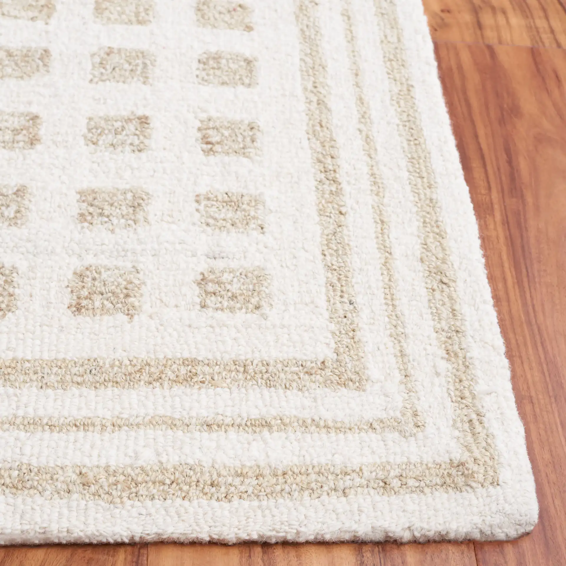 Ebony Checkered Hand-Tufted Rug in Ivory / Beige in a styled room