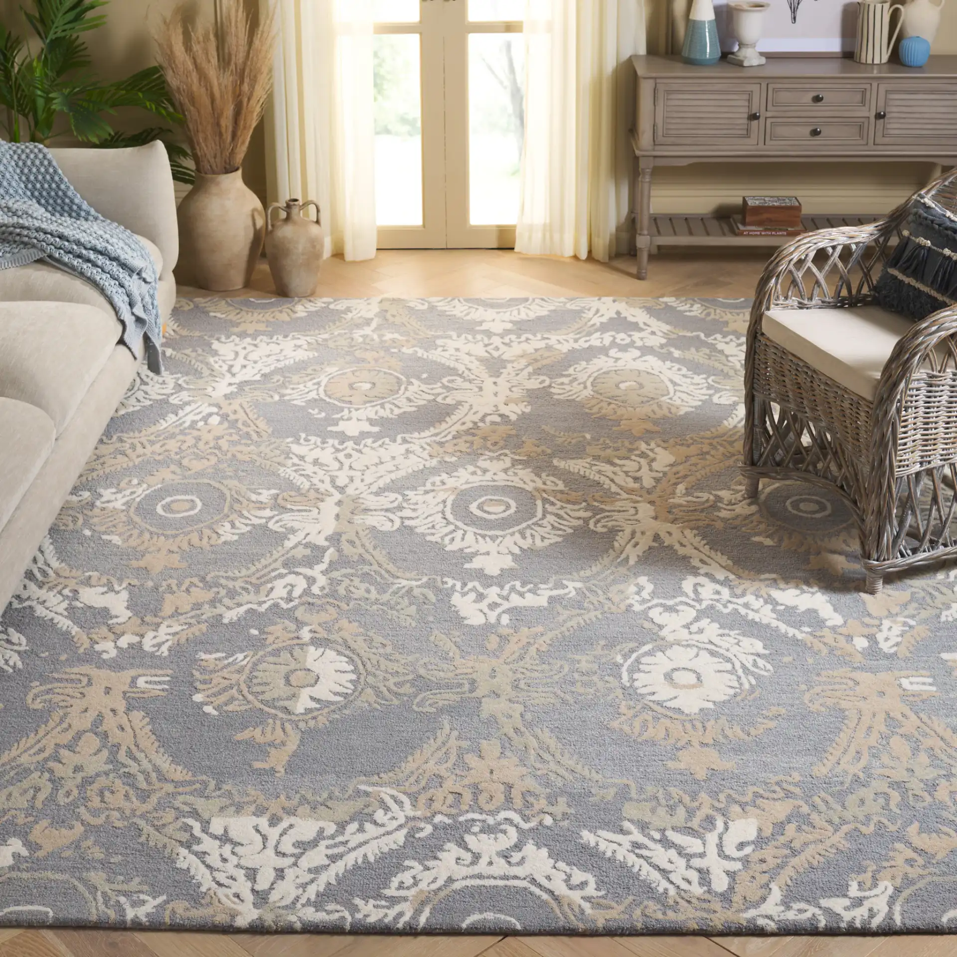 Ebony Scrolling Damask Hand-Tufted Wool Rug in Gray / Ivory in a styled room
