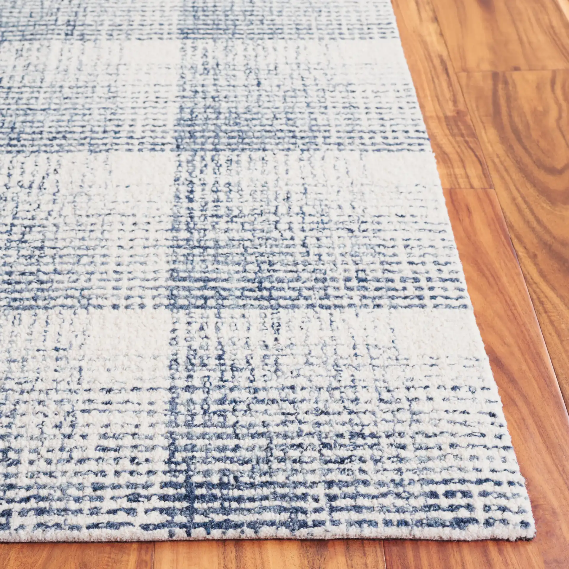 Ebony Plaid Hand-Tufted Wool Rug in Ivory / Blue in a styled room