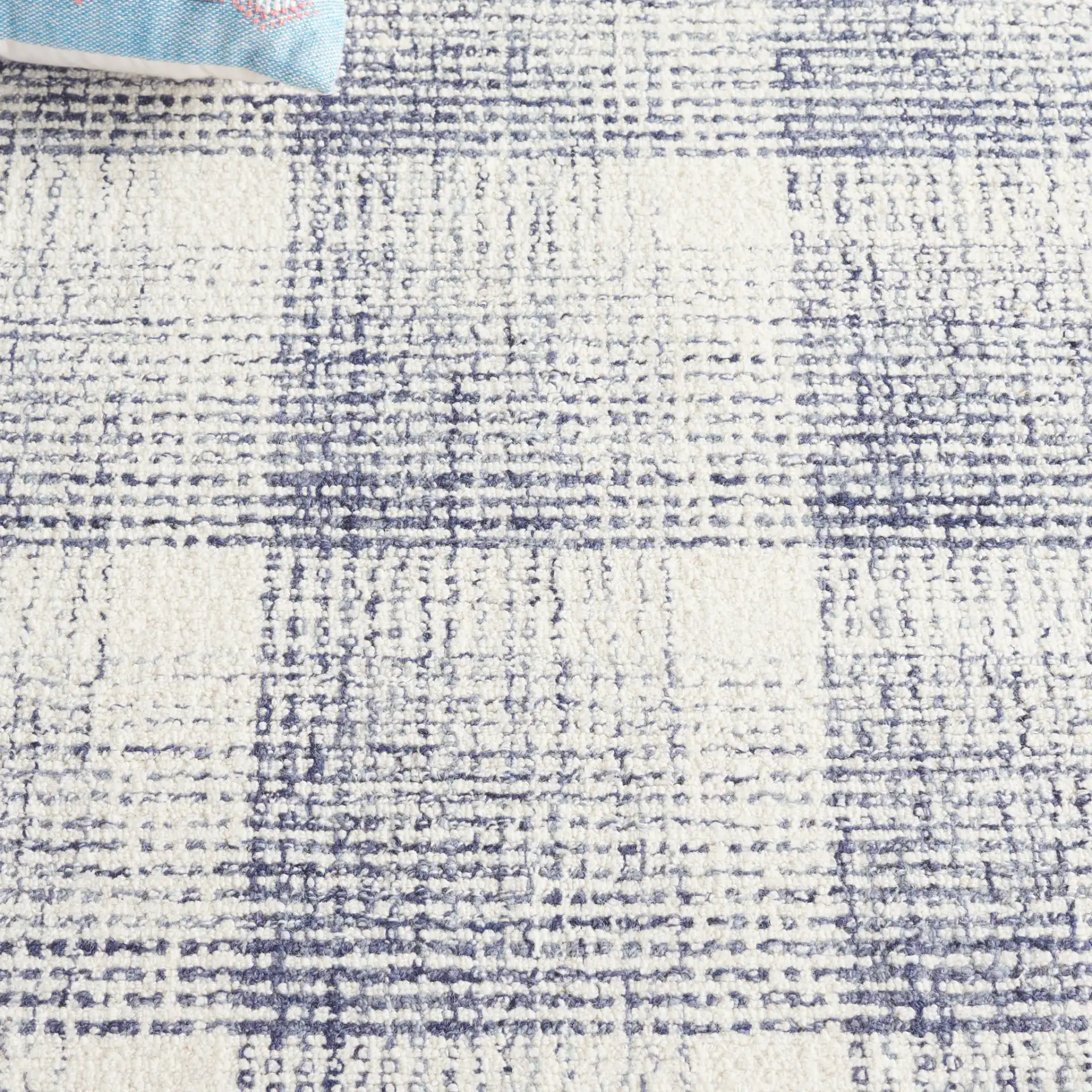 Ebony Plaid Hand-Tufted Wool Rug in Ivory / Blue in a styled room