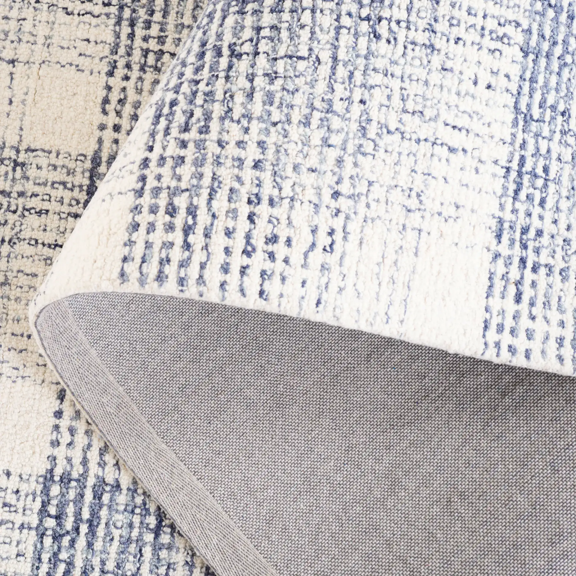 Ebony Plaid Hand-Tufted Wool Rug in Ivory / Blue in a styled room