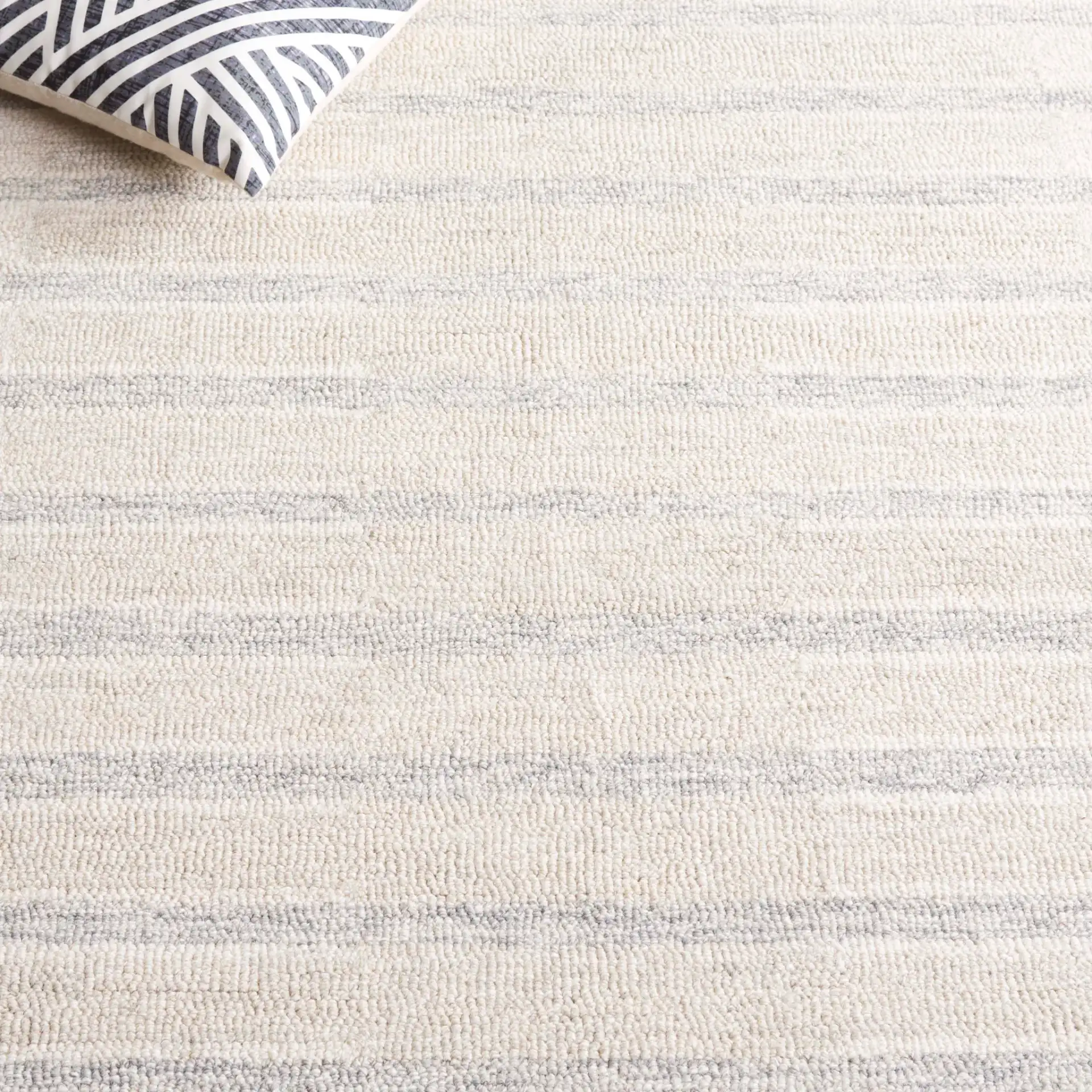 Ebony Horizontal Stripe Hand-Tufted Wool Rug in Beige / Gray in a styled room