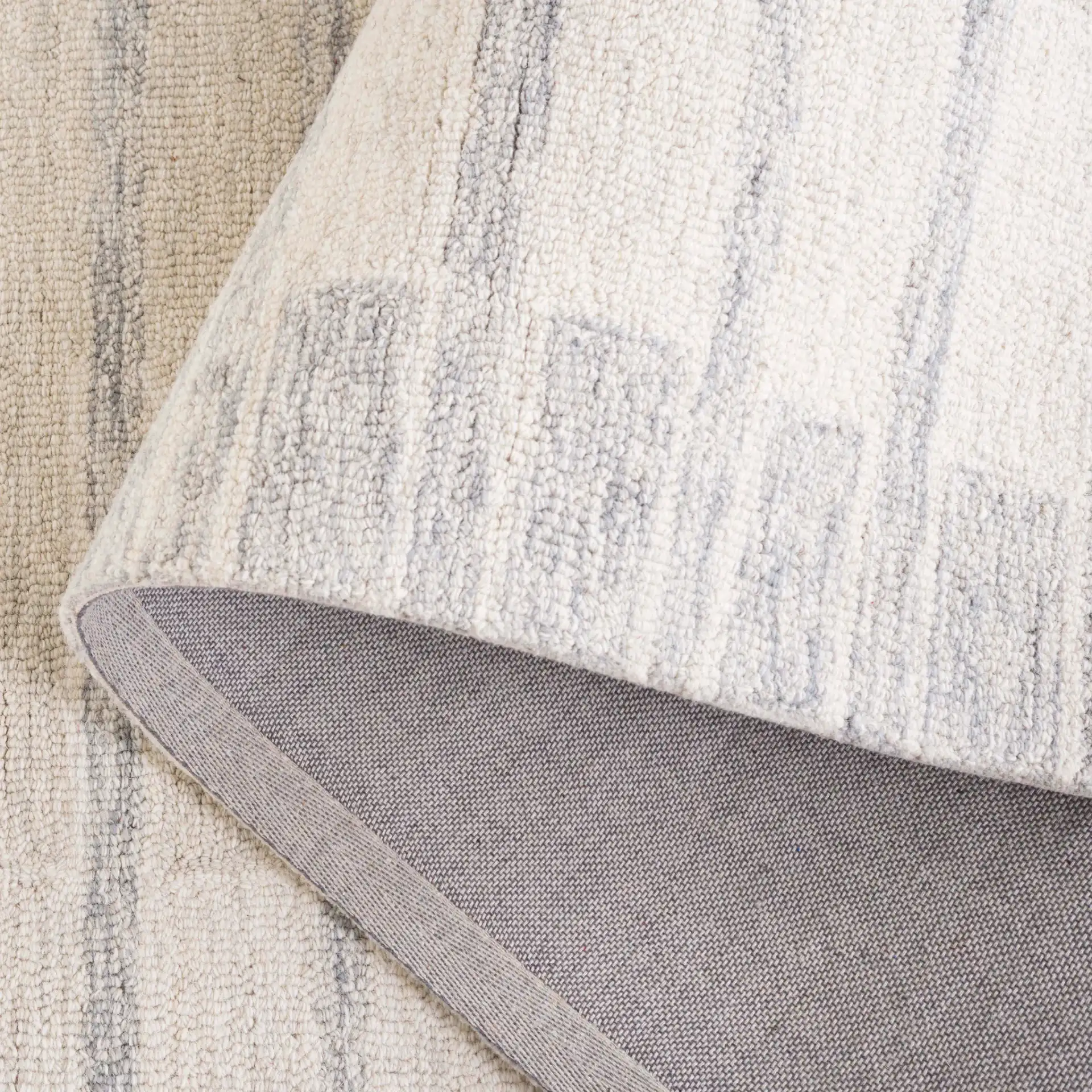 Ebony Horizontal Stripe Hand-Tufted Wool Rug in Beige / Gray in a styled room