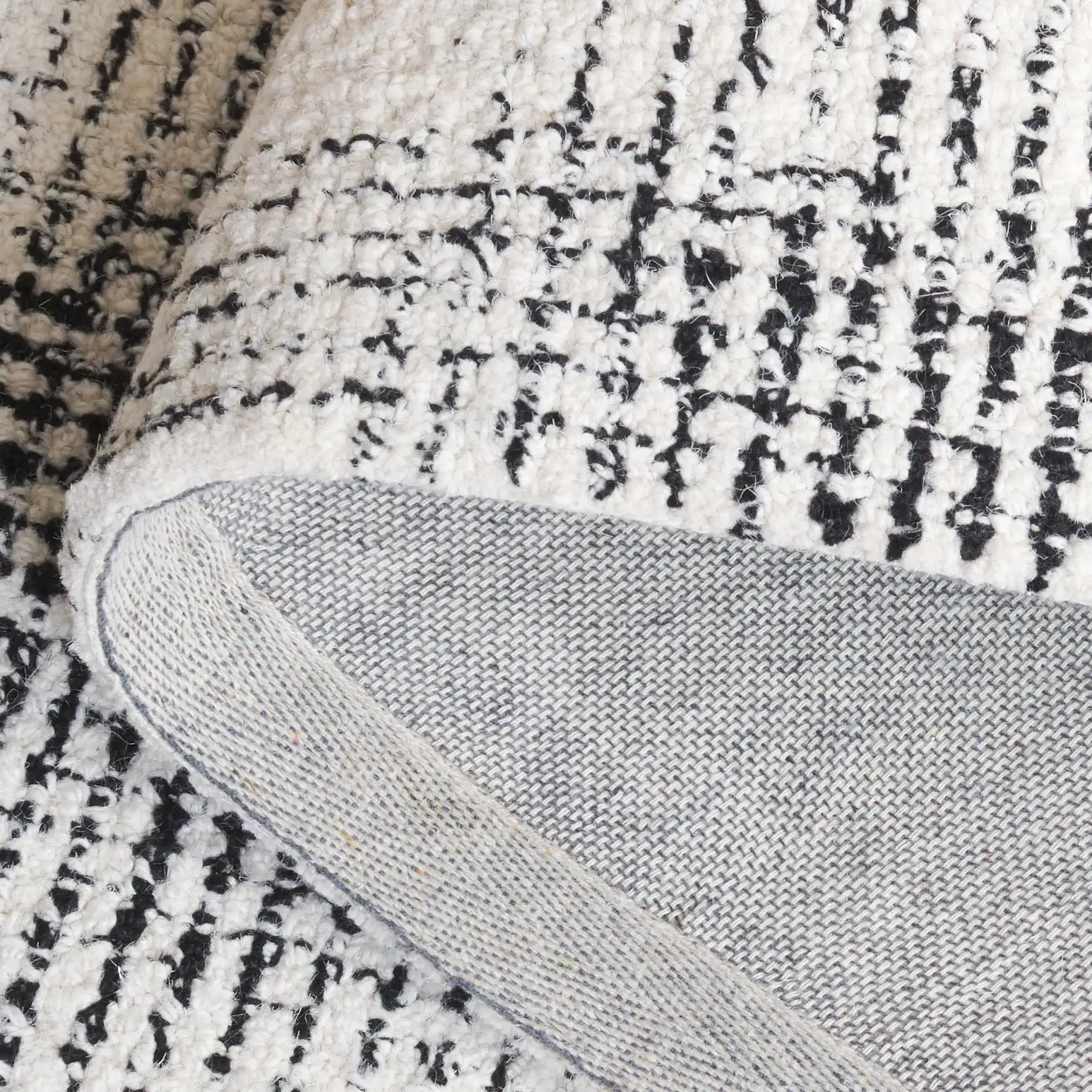 Ebony Gingham Plaid Hand-Tufted Wool Rug in Ivory / Black in a styled room