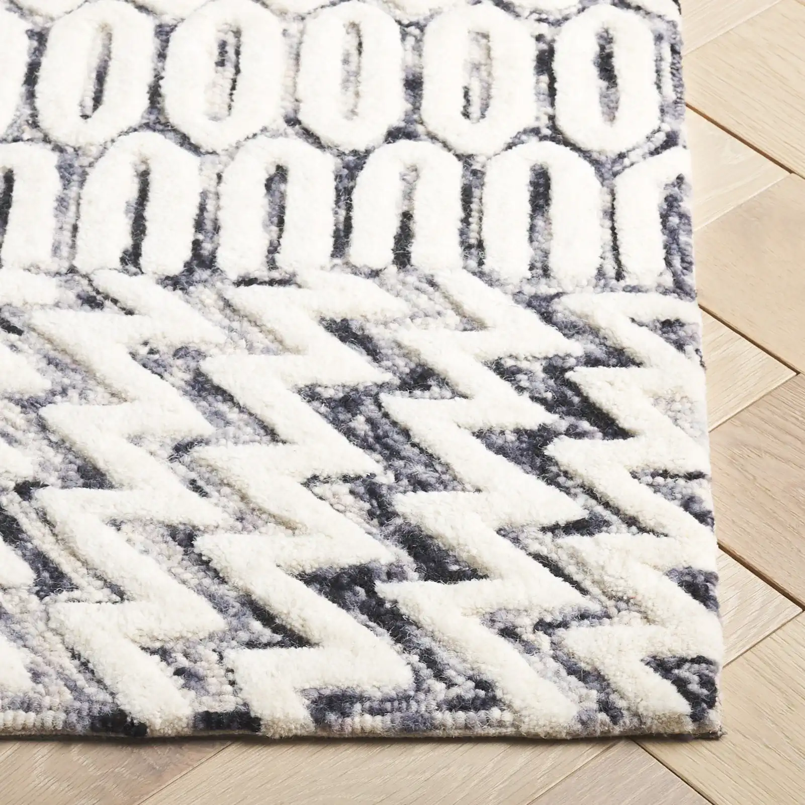 Ebony Patchwork Hand-Tufted Wool Rug in Ivory / Black in a styled room