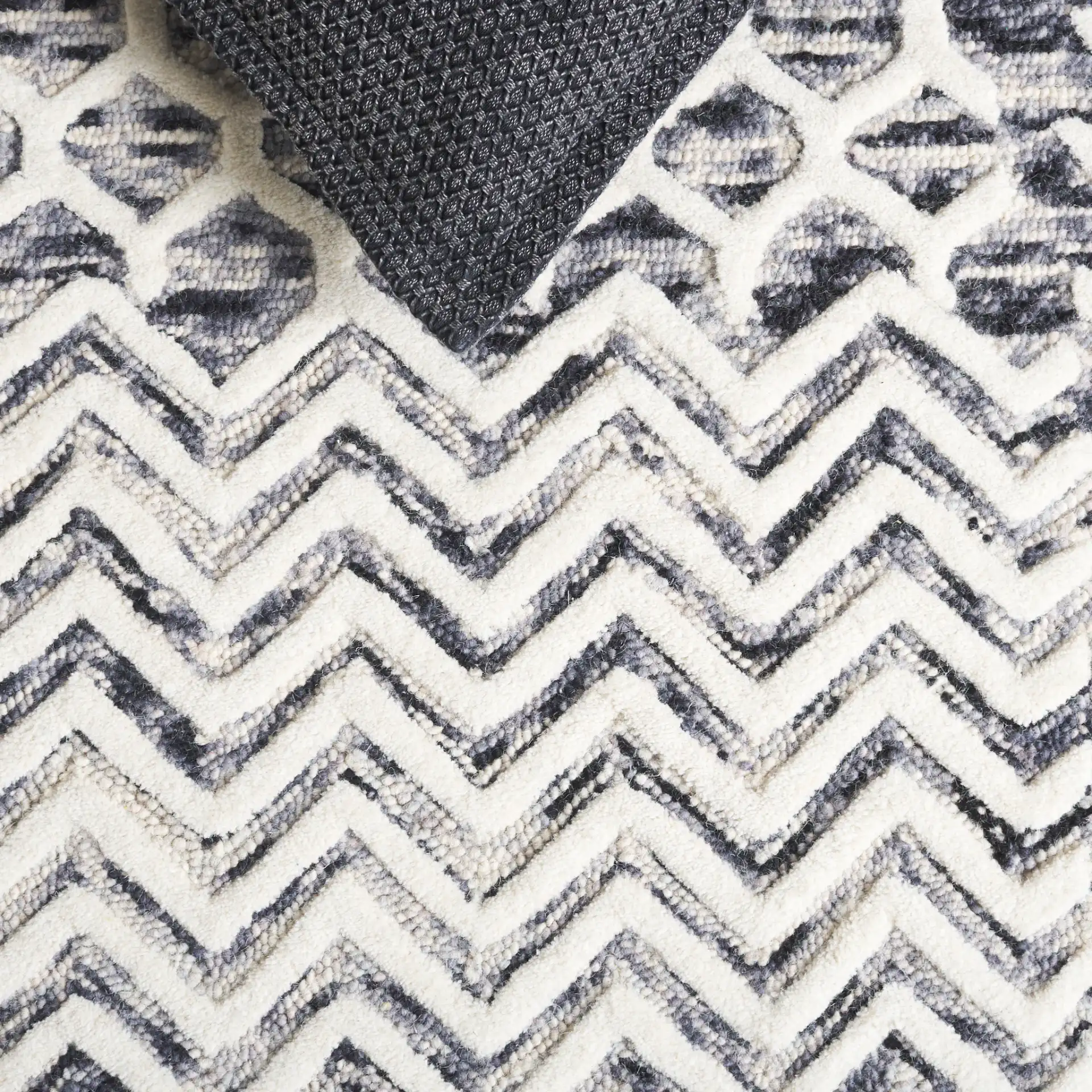 Ebony Patchwork Hand-Tufted Wool Rug in Ivory / Black in a styled room