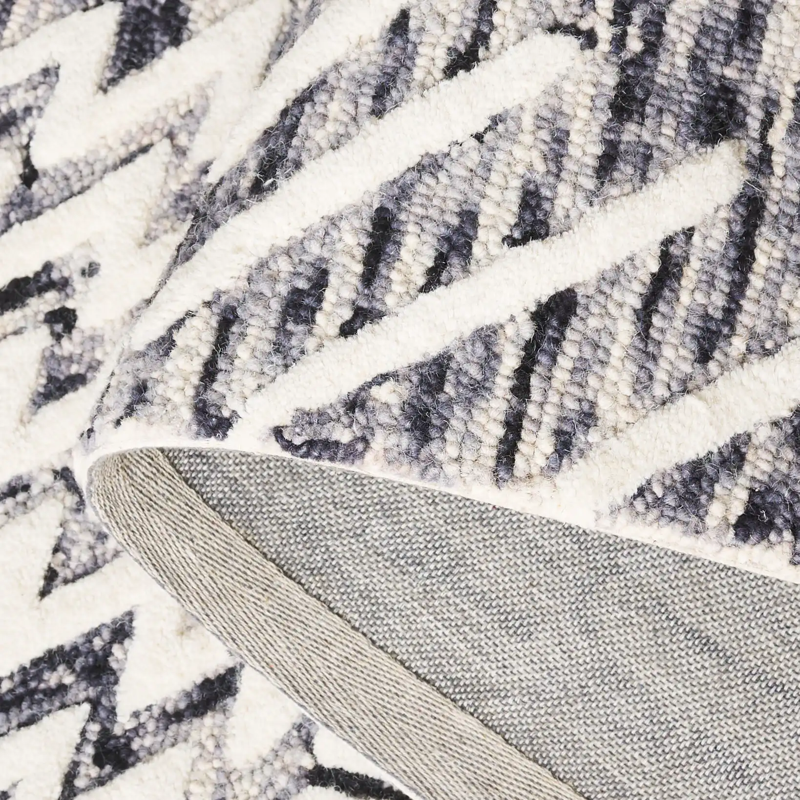 Ebony Patchwork Hand-Tufted Wool Rug in Ivory / Black in a styled room