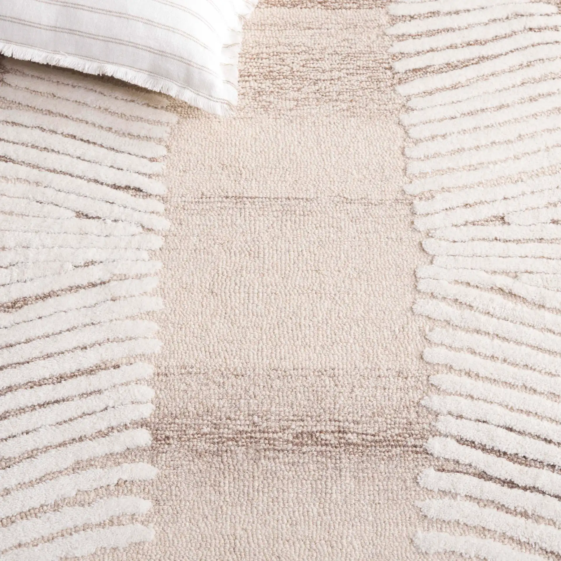 Ebony Radiating Border Hand-Tufted Wool Rug in Ivory / Brown in a styled room