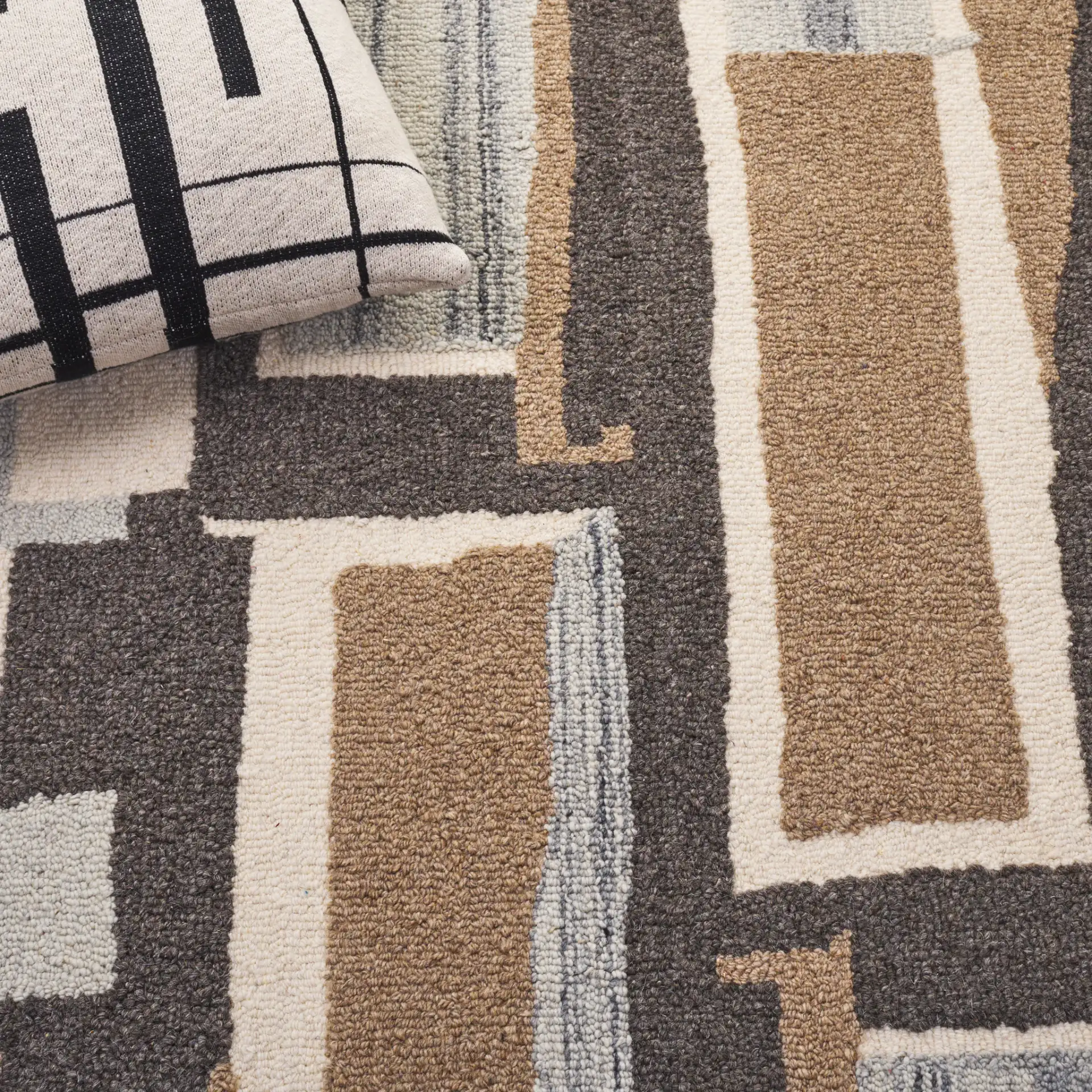 Ebony Abstract Patchwork Collage Hand-Tufted Wool Rug in Ivory / Brown in a styled room