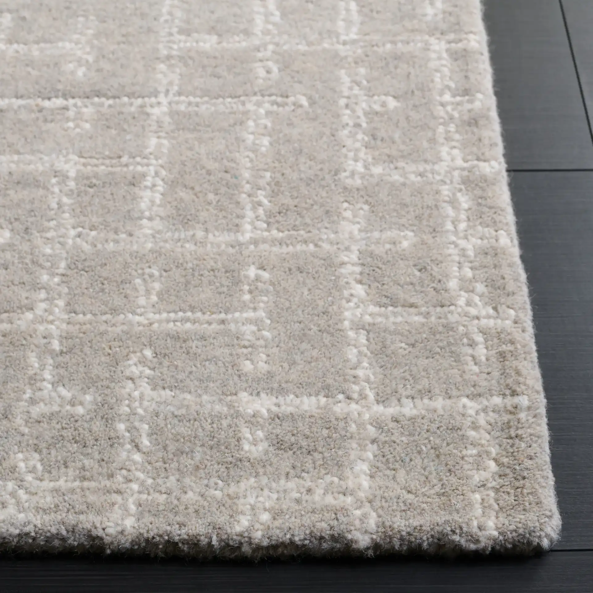 Ebony Intersecting Grid Hand-Tufted Wool Rug in Gray in a styled room