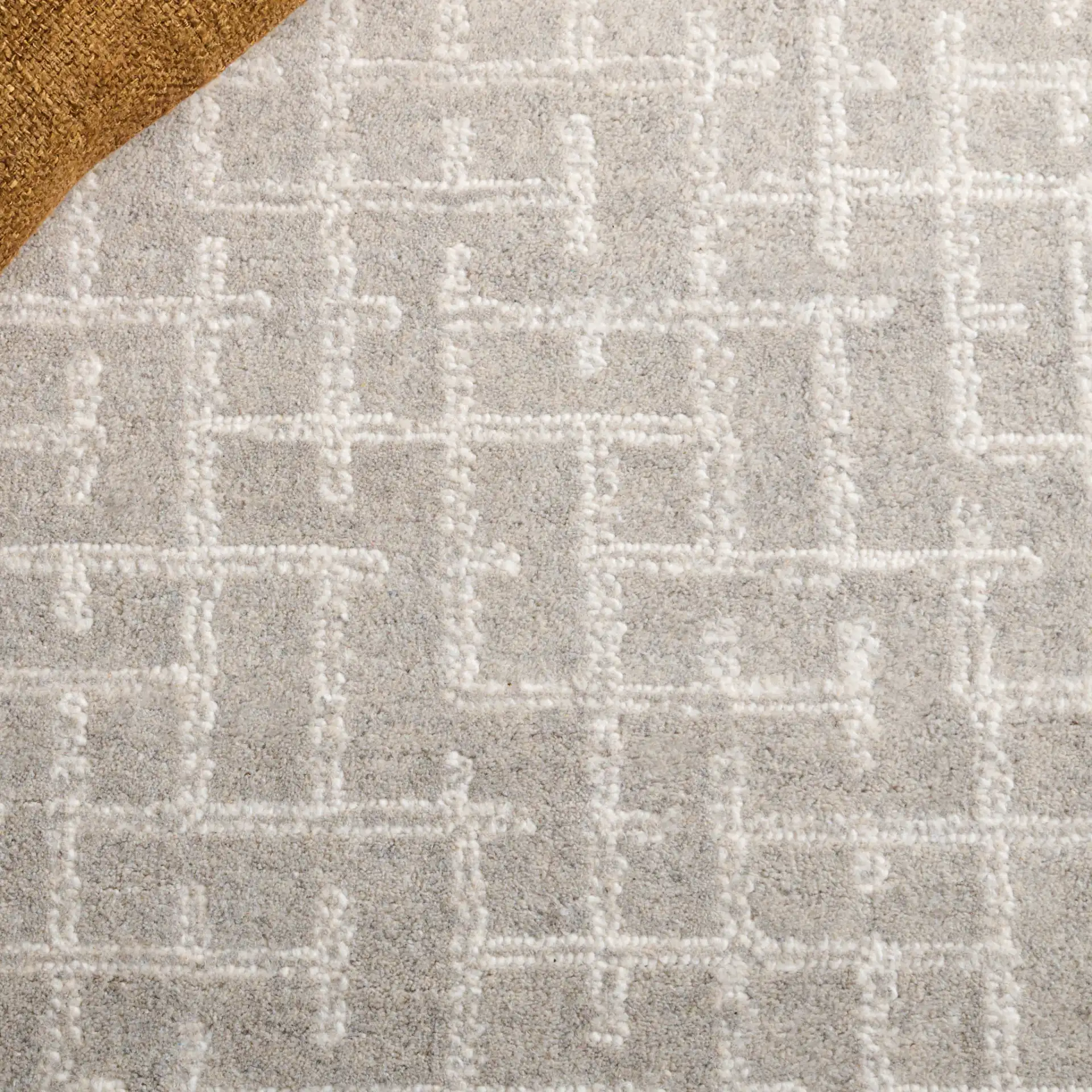 Ebony Intersecting Grid Hand-Tufted Wool Rug in Gray in a styled room
