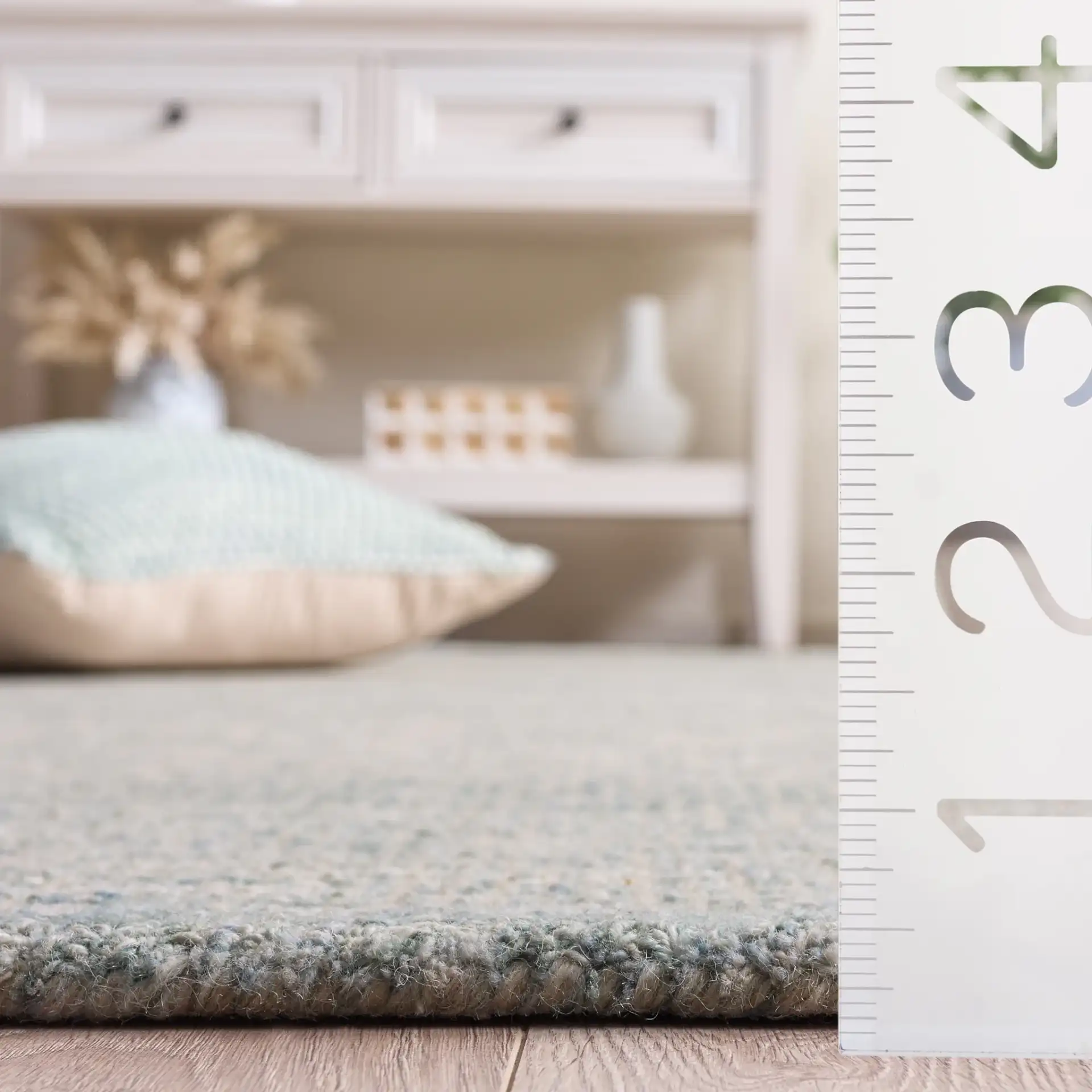 Ebony Bordered Solid Hand-Tufted Wool Rug in Light Blue in a styled room