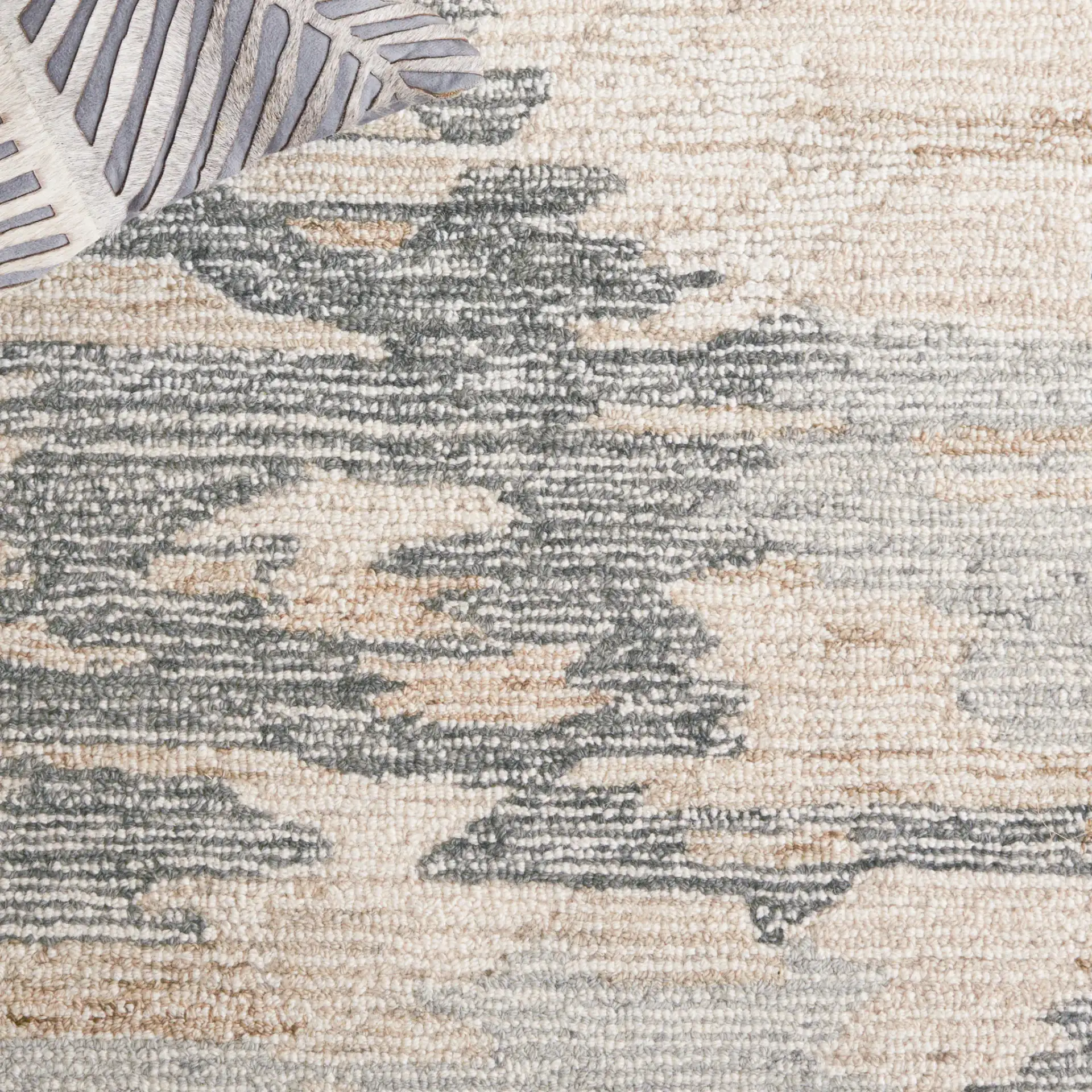 Ebony Distressed Abstract Hand-Tufted Wool Rug in Gray / Ivory in a styled room