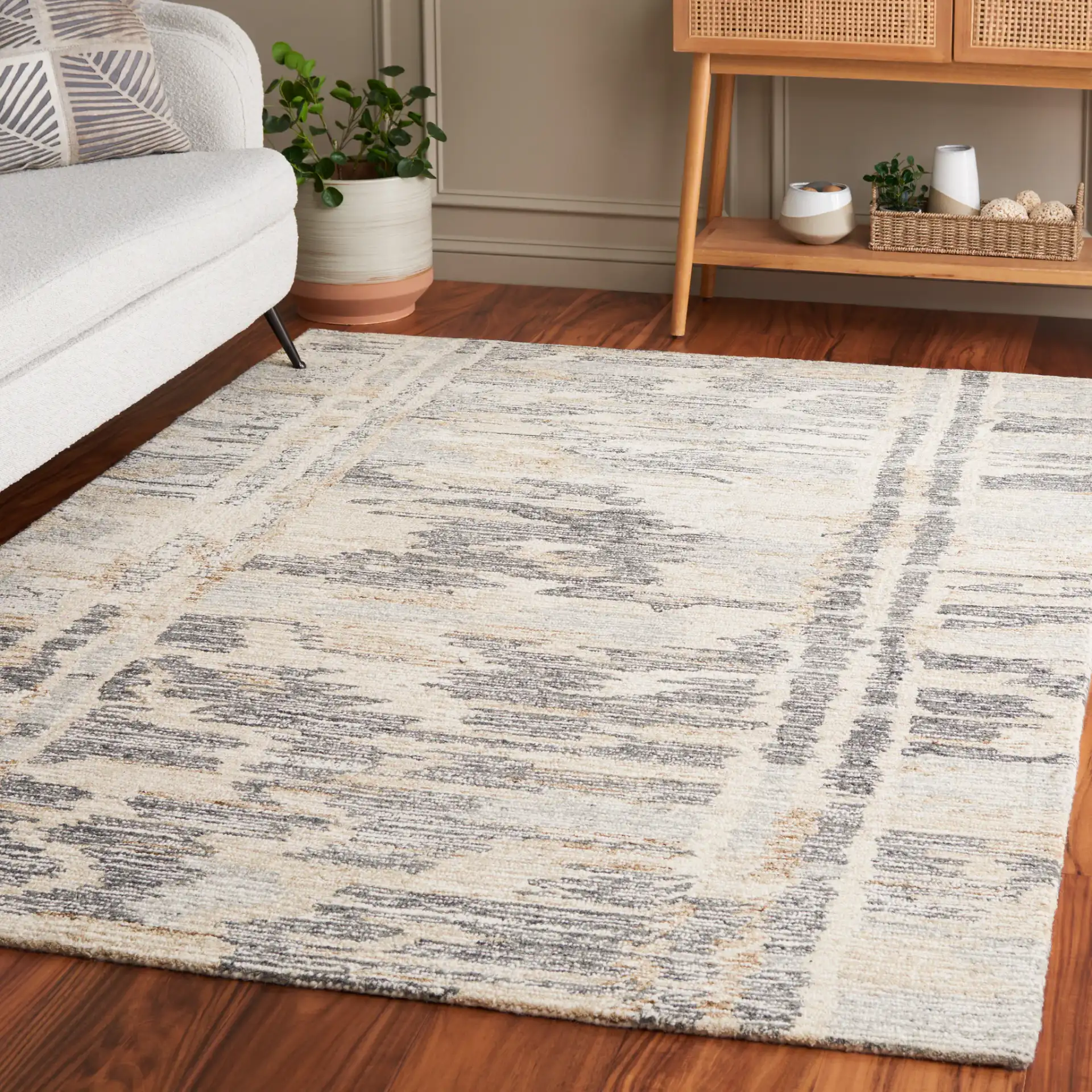 Ebony Distressed Abstract Hand-Tufted Wool Rug in Gray / Ivory in a styled room
