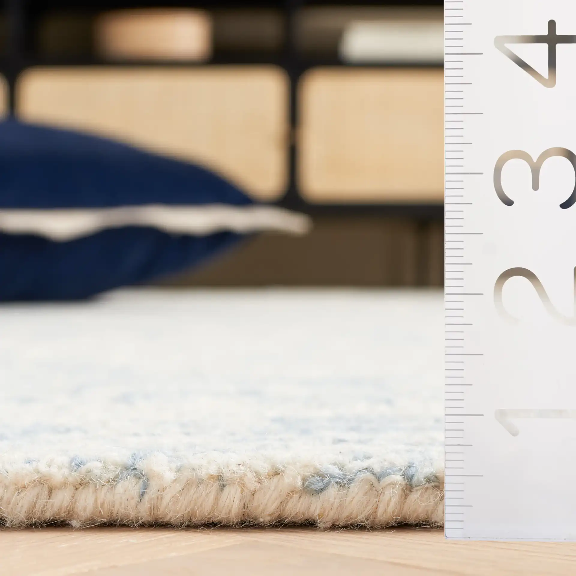 Ebony Abstract Mottled Hand-Tufted Wool Rug in Ivory / Blue in a styled room