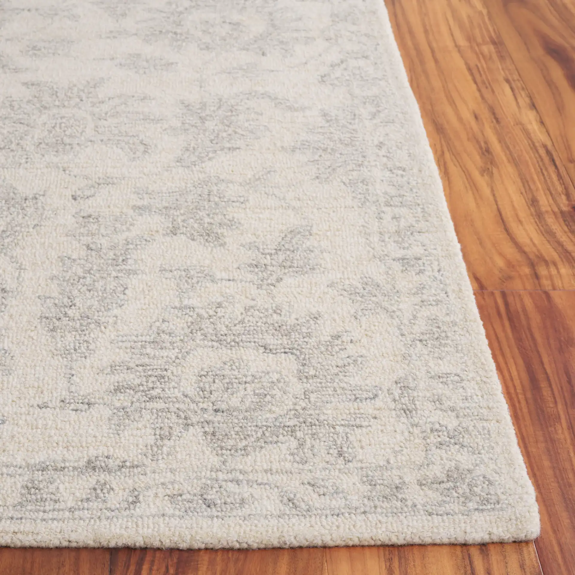 Ebony Floral Hand-Tufted Wool Rug in Ivory / Gray in a styled room