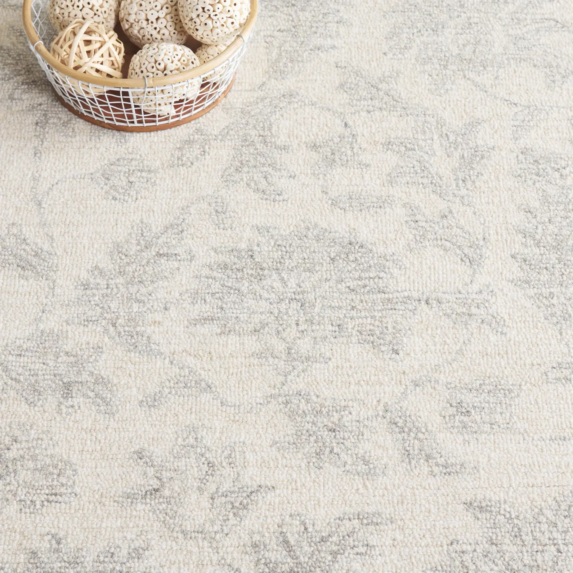 Ebony Floral Hand-Tufted Wool Rug in Ivory / Gray in a styled room