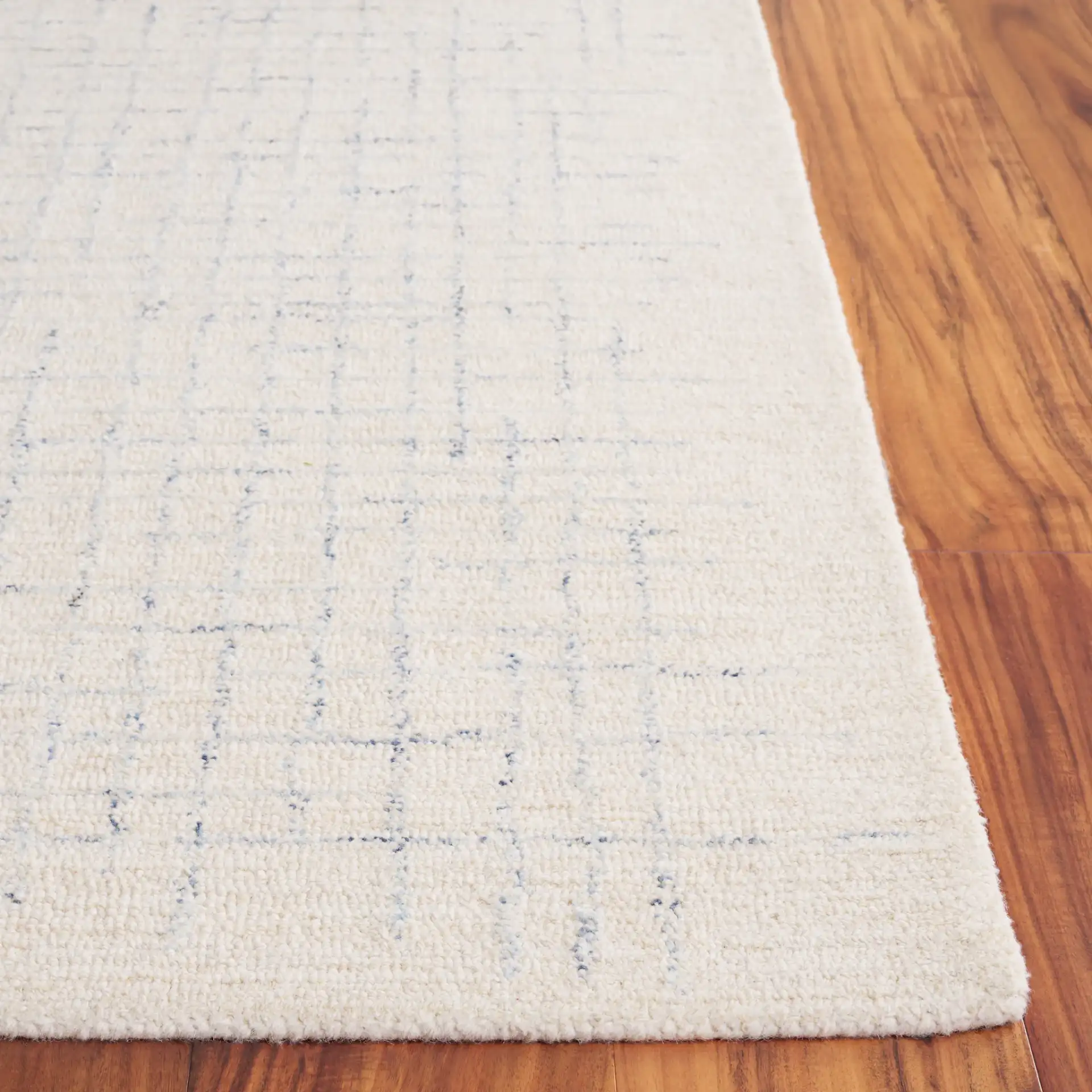 Ebony Broken Grid Hand-Tufted Wool Rug in Ivory / Navy in a styled room