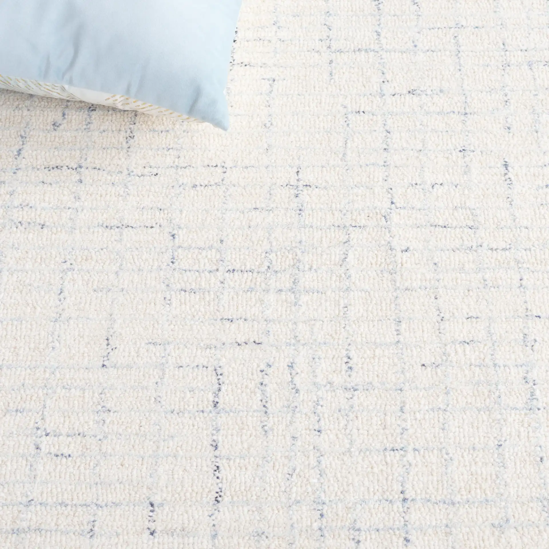 Ebony Broken Grid Hand-Tufted Wool Rug in Ivory / Navy in a styled room