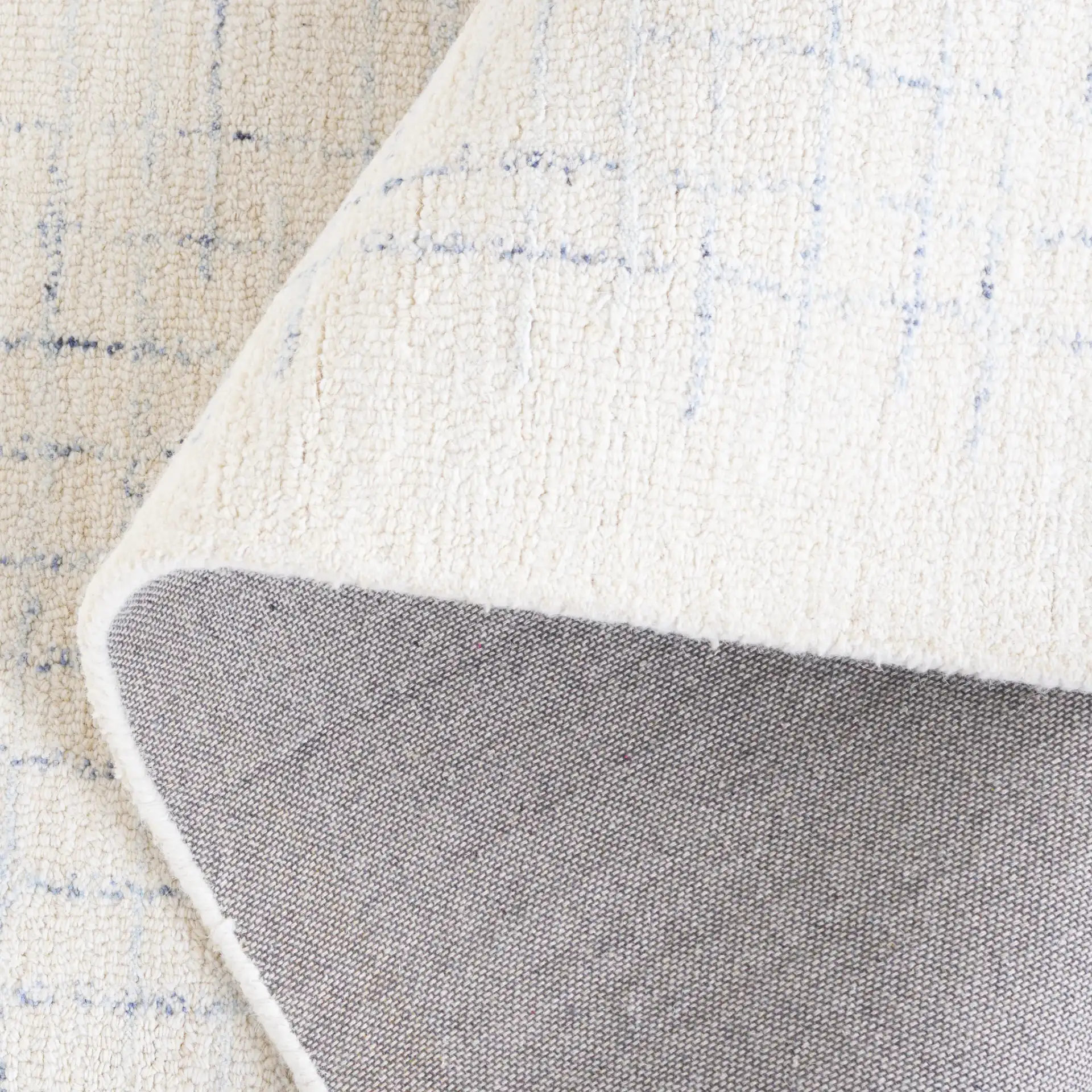 Ebony Broken Grid Hand-Tufted Wool Rug in Ivory / Navy in a styled room