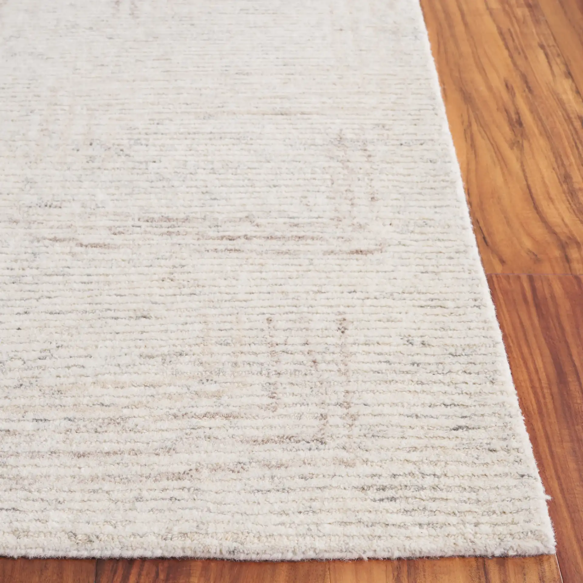 Ebony Subtle Grid Hand-Tufted Wool Rug in Ivory / Beige in a styled room