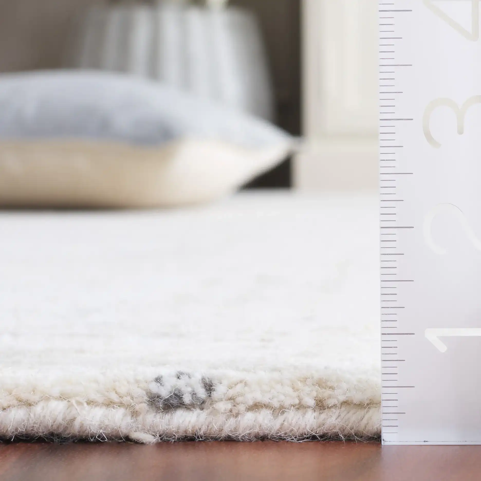 Ebony Subtle Grid Hand-Tufted Wool Rug in Ivory / Beige in a styled room