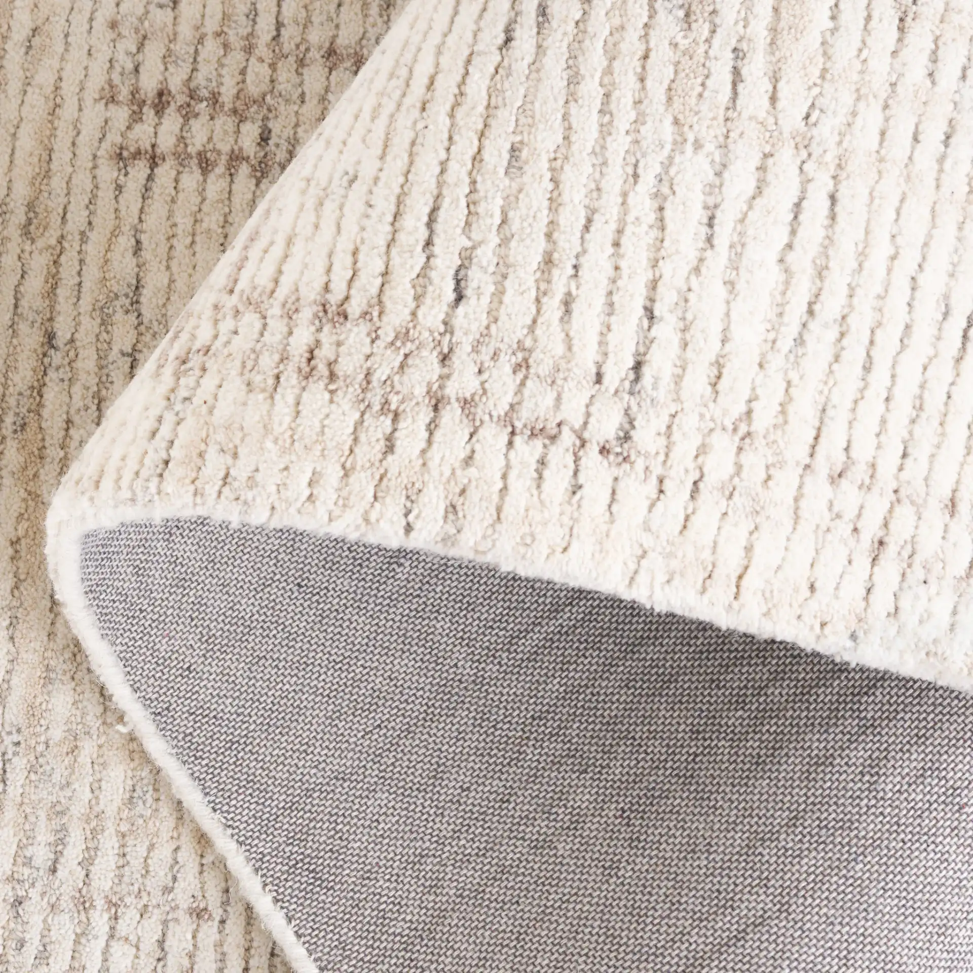 Ebony Subtle Grid Hand-Tufted Wool Rug in Ivory / Beige in a styled room