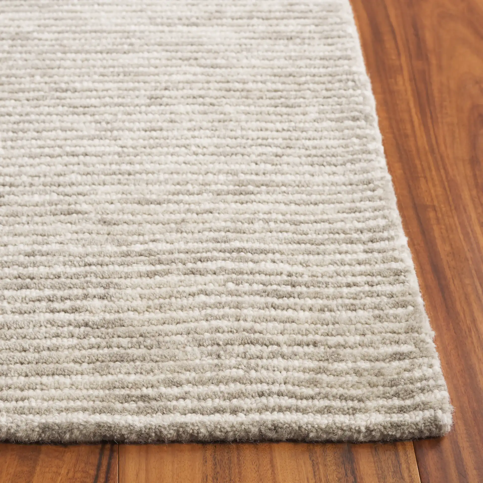 Ebony Ribbed Hand-Tufted Wool Rug in Green / Ivory in a styled room