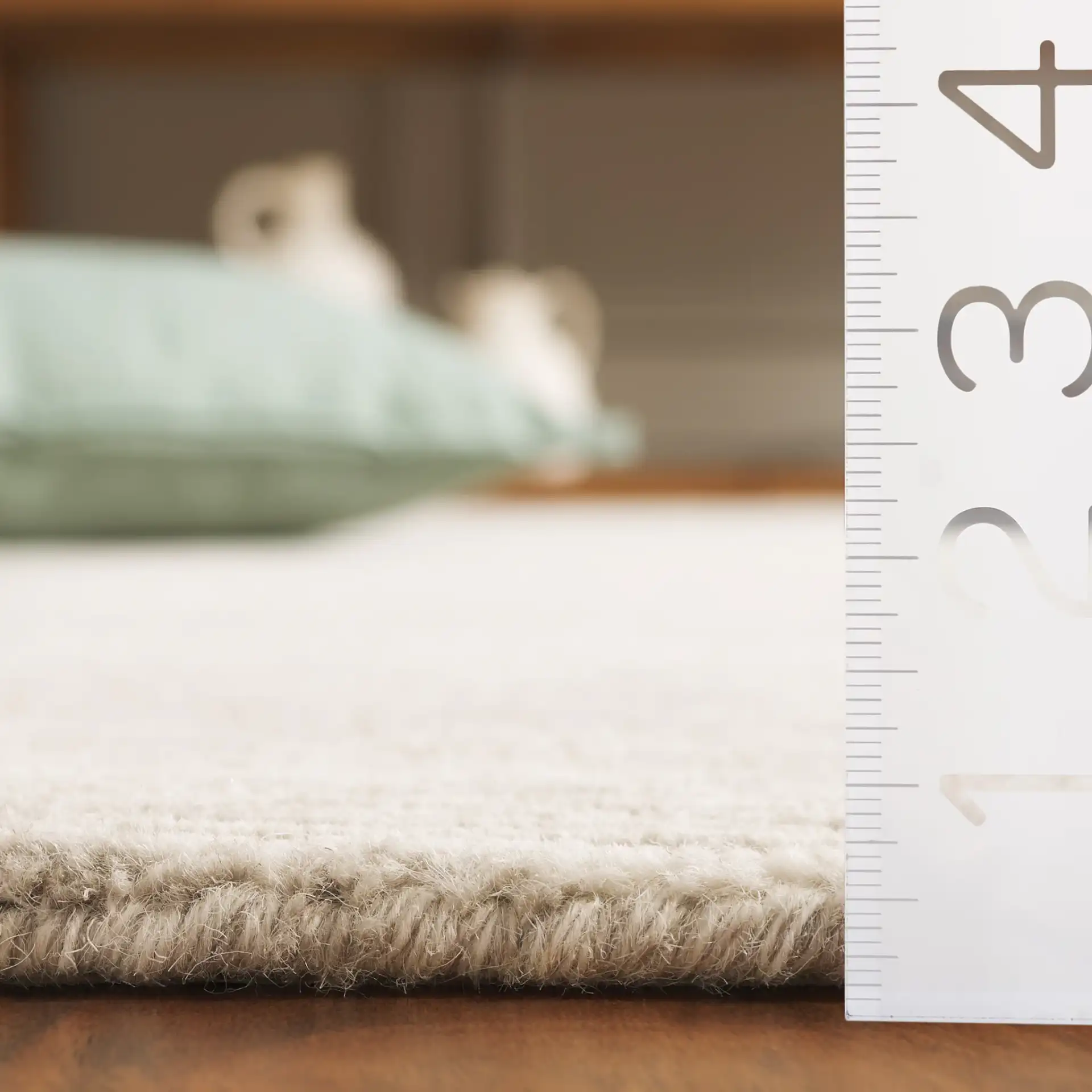 Ebony Ribbed Hand-Tufted Wool Rug in Green / Ivory in a styled room