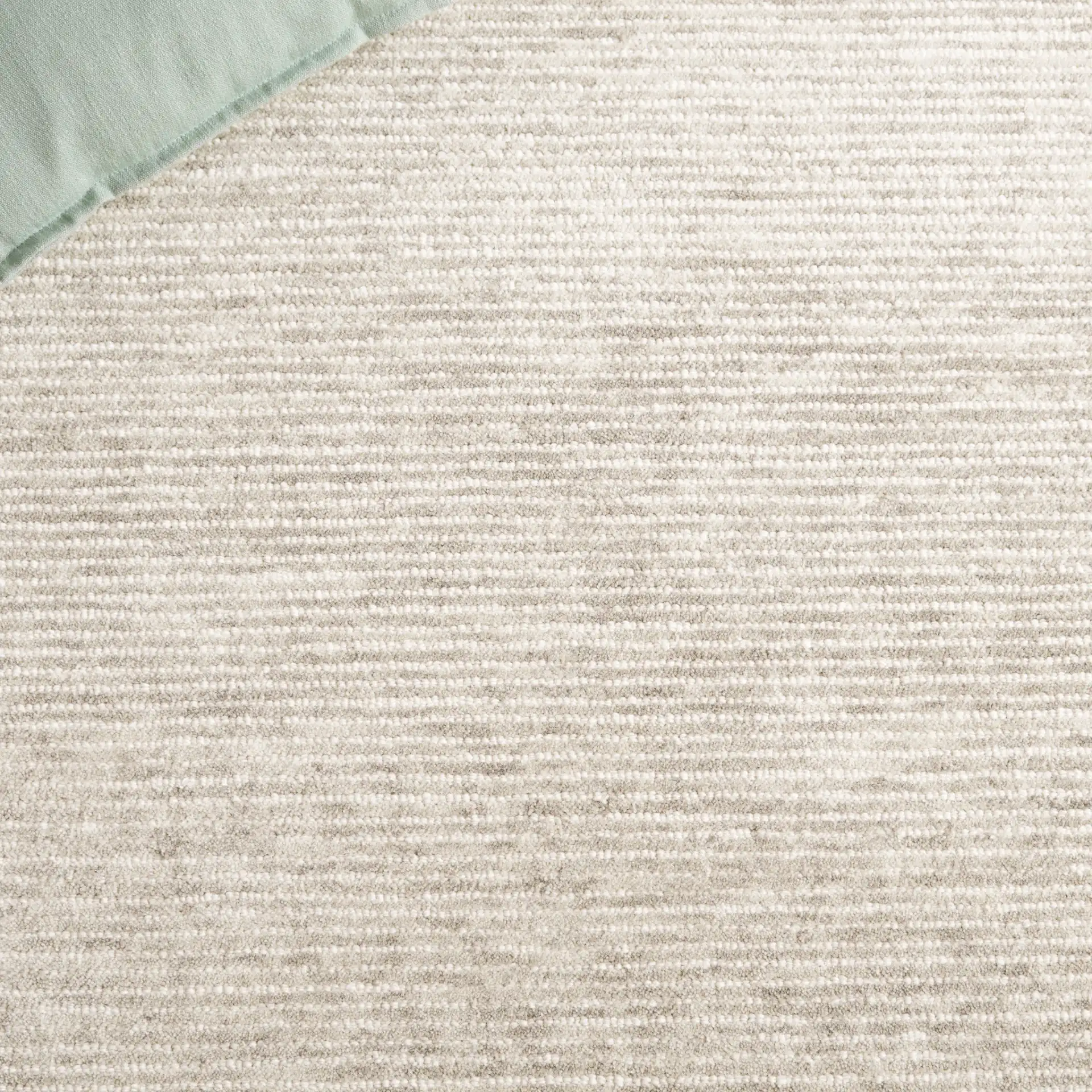 Ebony Ribbed Hand-Tufted Wool Rug in Green / Ivory in a styled room