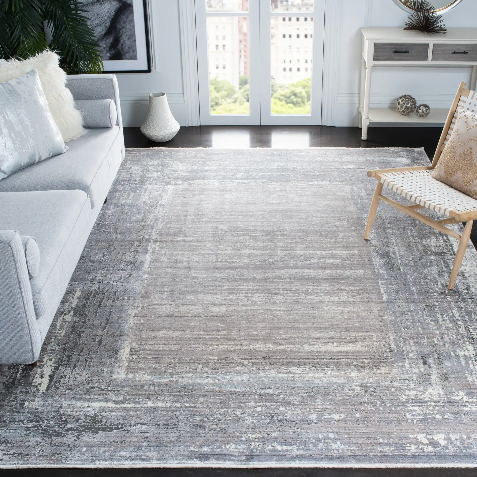 Eclipse Framed Abstract Rug in Gray / Beige in a styled room