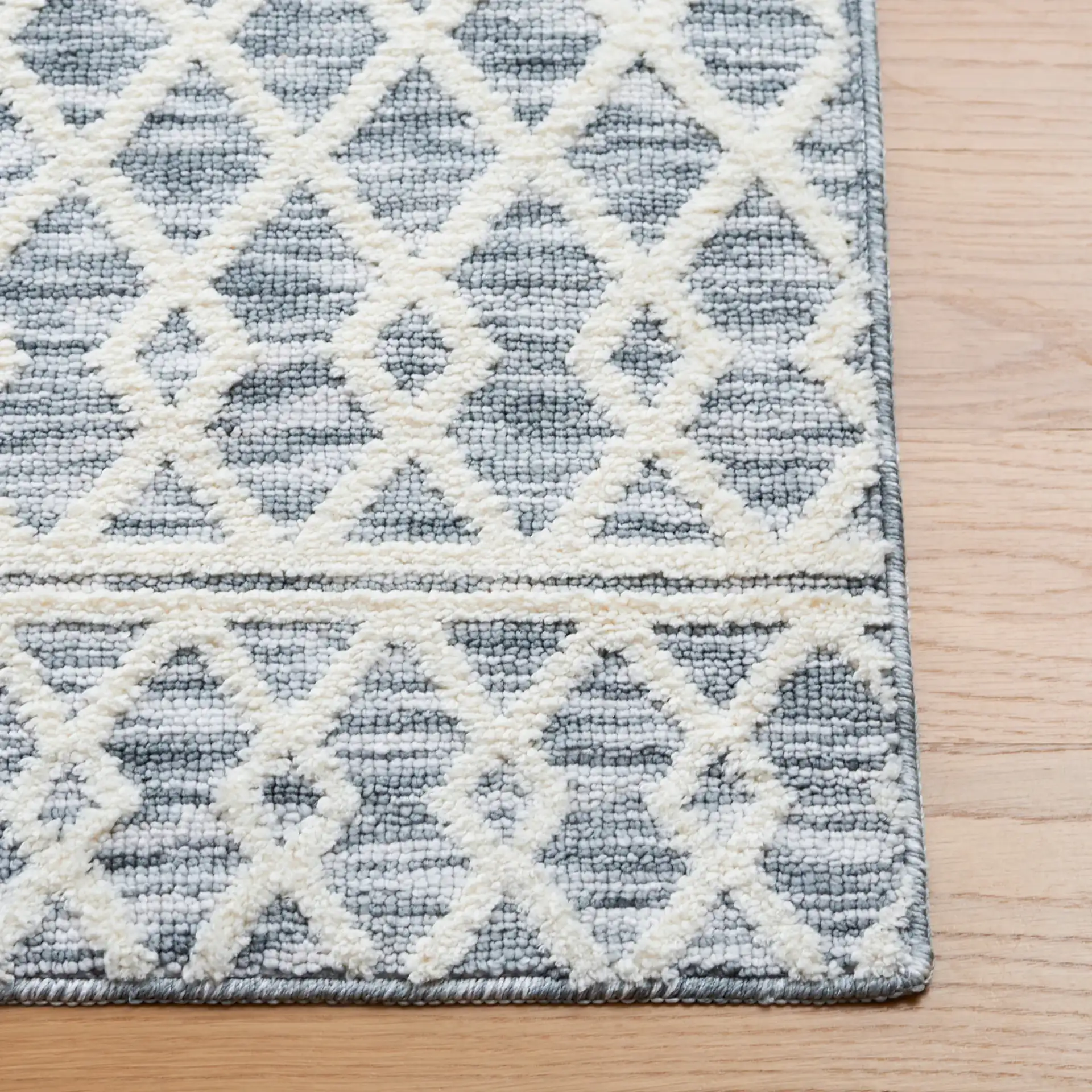 Easy Care Diamond Lattice Washable Rug in Gray / Ivory in a styled room