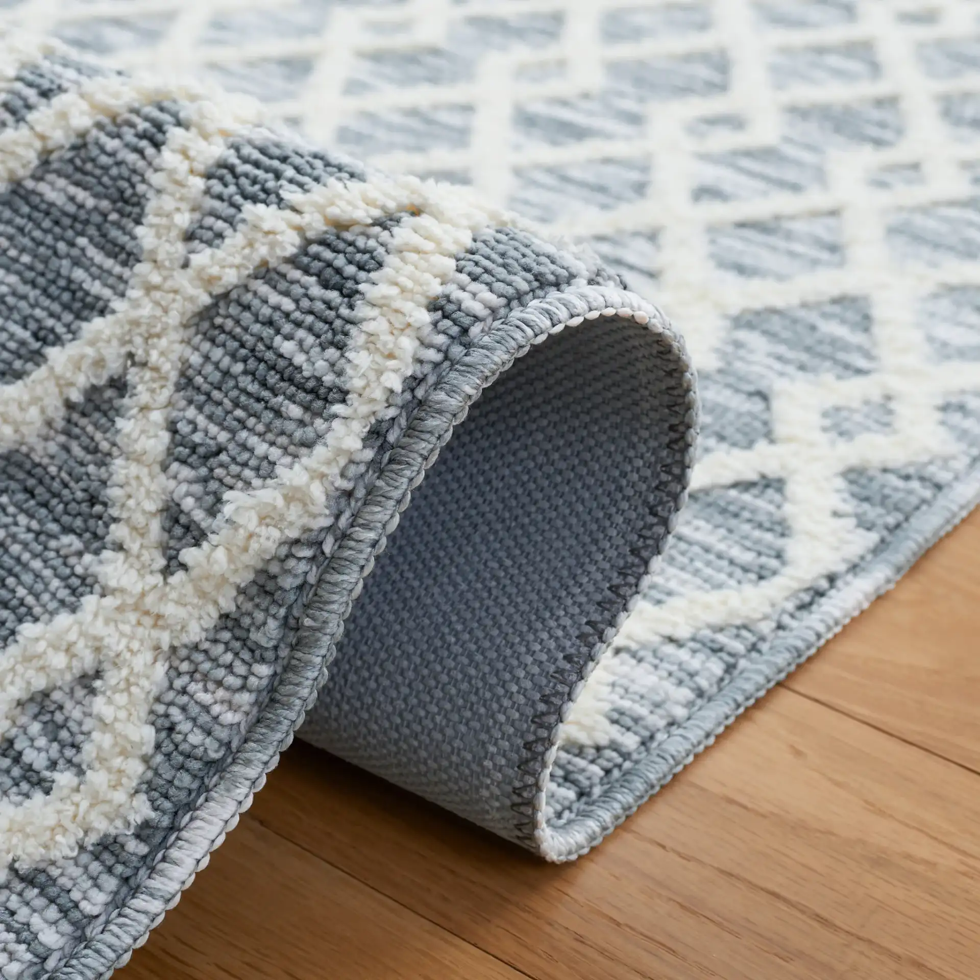 Easy Care Diamond Lattice Washable Rug in Gray / Ivory in a styled room