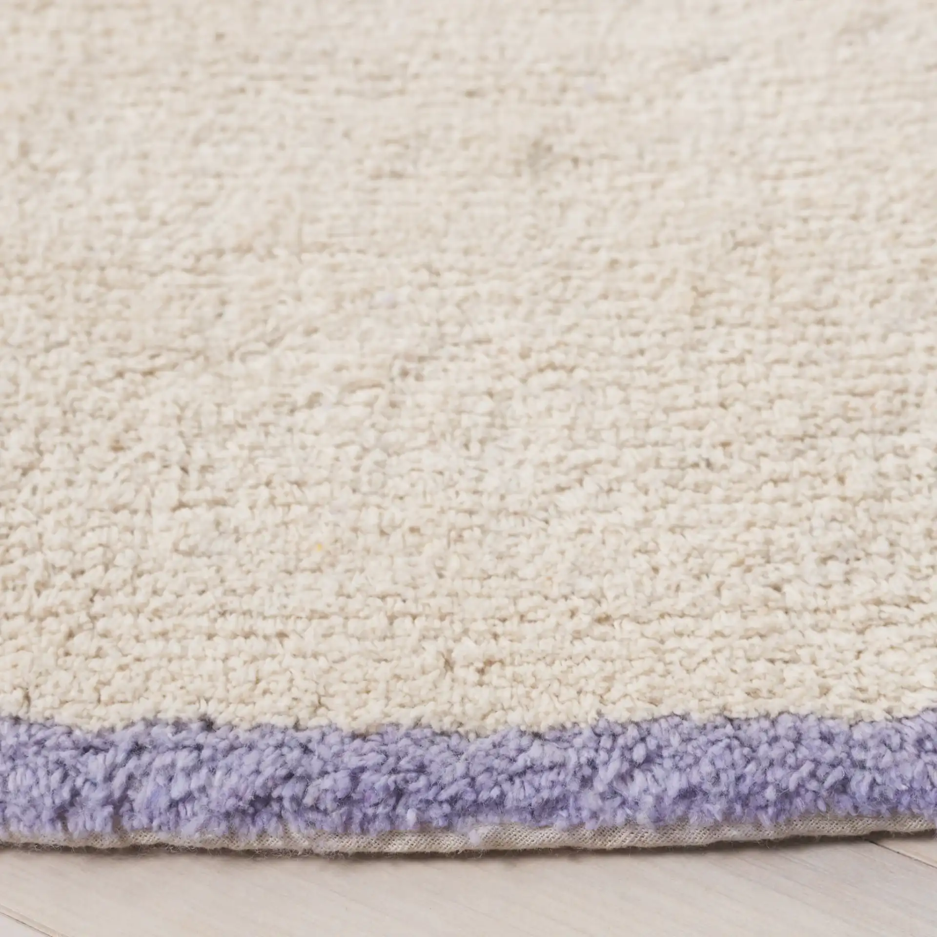 Easy Care Bordered Hand-Tufted Cotton Washable Rug in Ivory / Lilac in a styled room