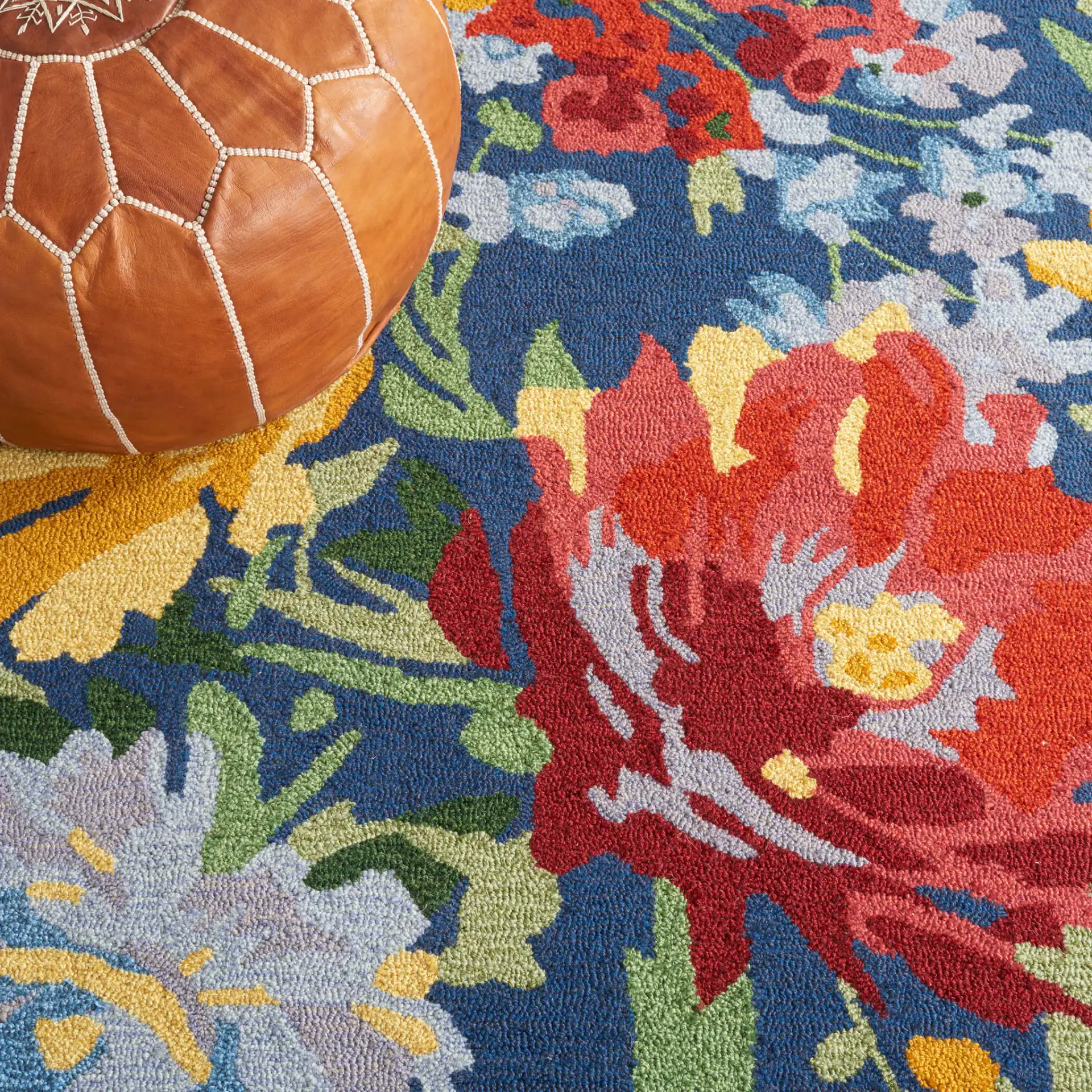 Easy Care Dense Floral Hand-Tufted Rug in Navy / Red in a styled room