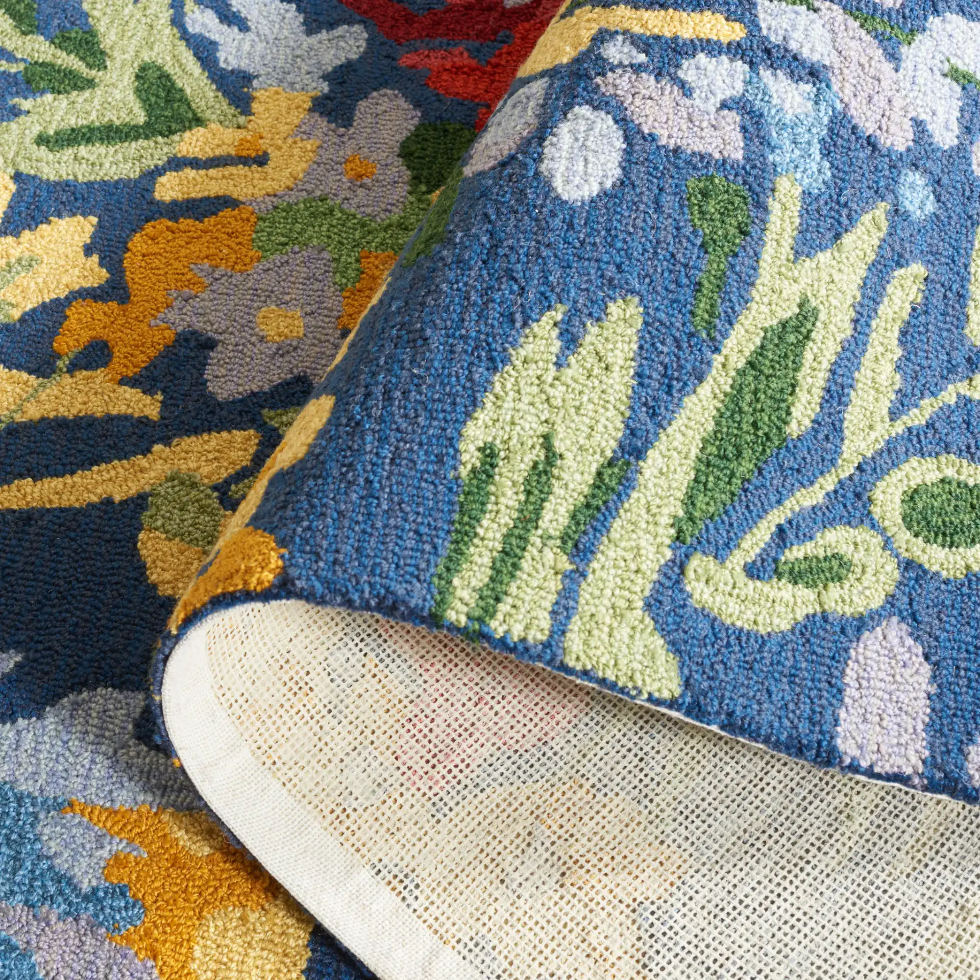 Easy Care Dense Floral Hand-Tufted Rug in Navy / Red in a styled room