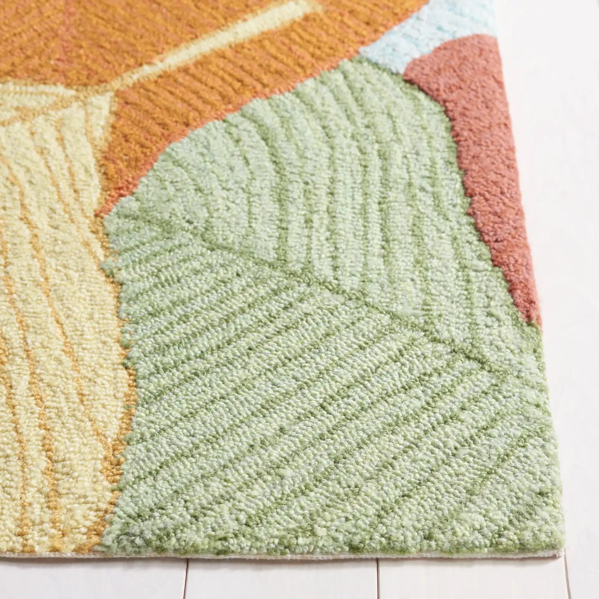 Easy Care Overlapping Leaves Hand-Tufted Rug in Rust / Green in a styled room