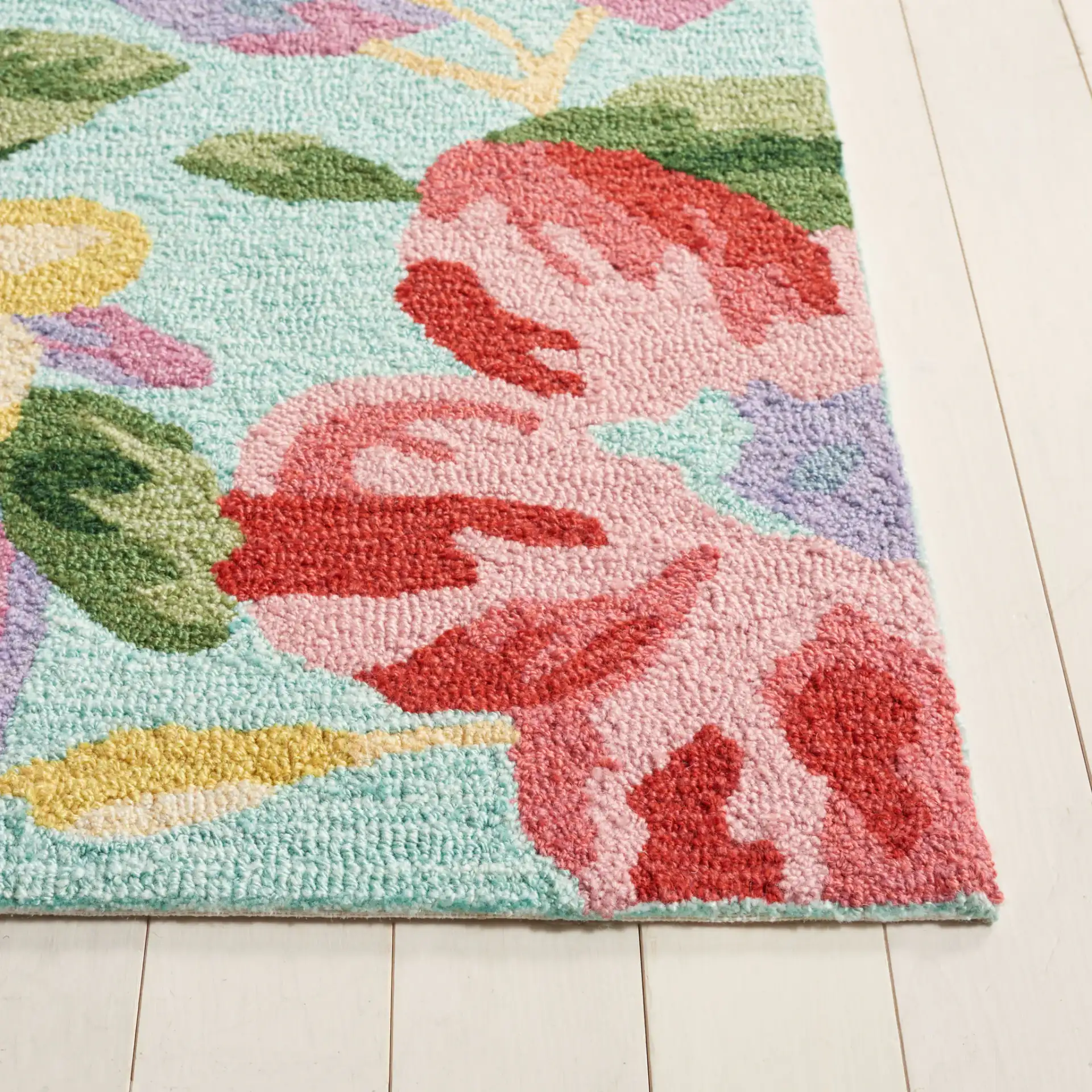 Easy Care Floral Bloom Hand-Tufted Rug in Blue / Pink in a styled room