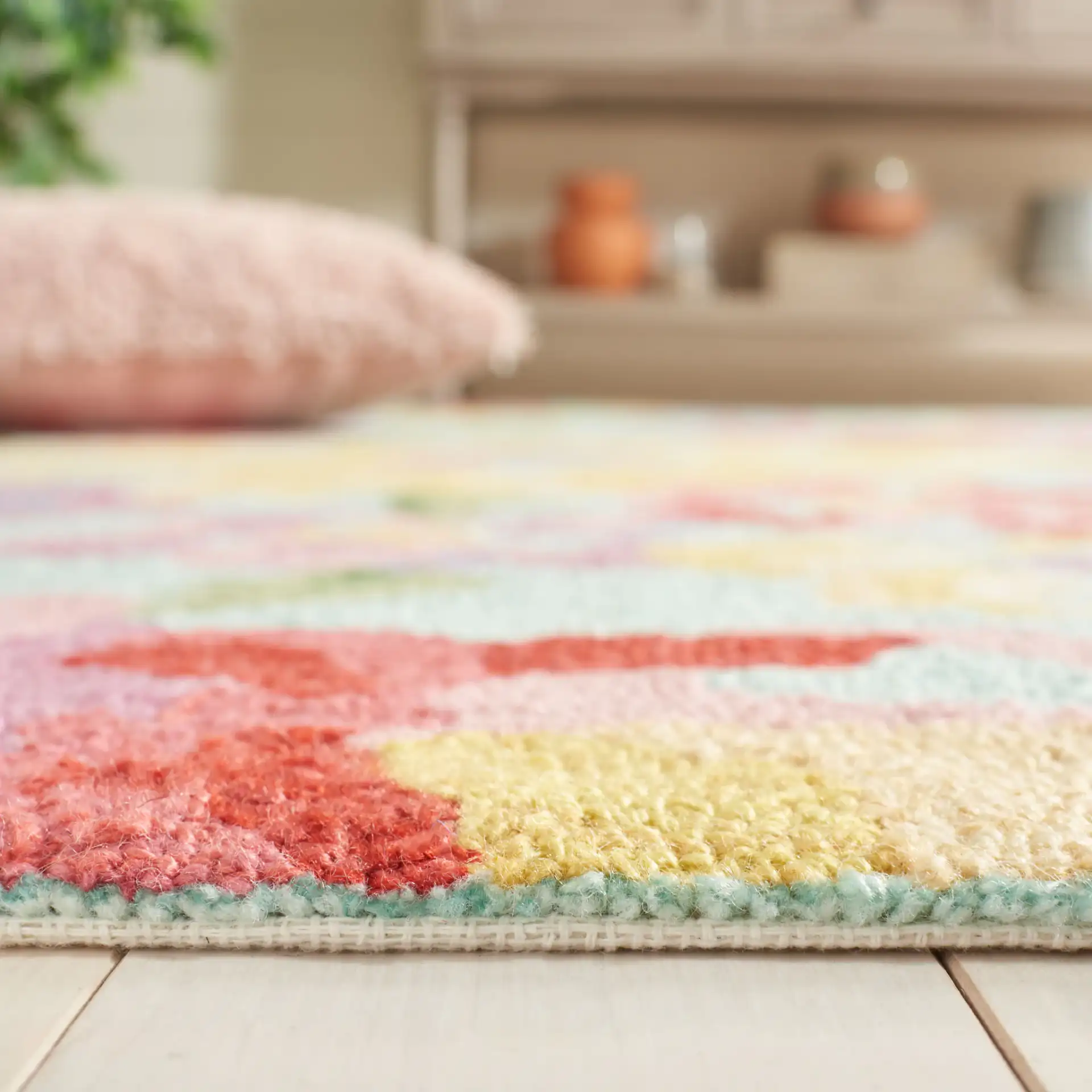 Easy Care Floral Bloom Hand-Tufted Rug in Blue / Pink in a styled room
