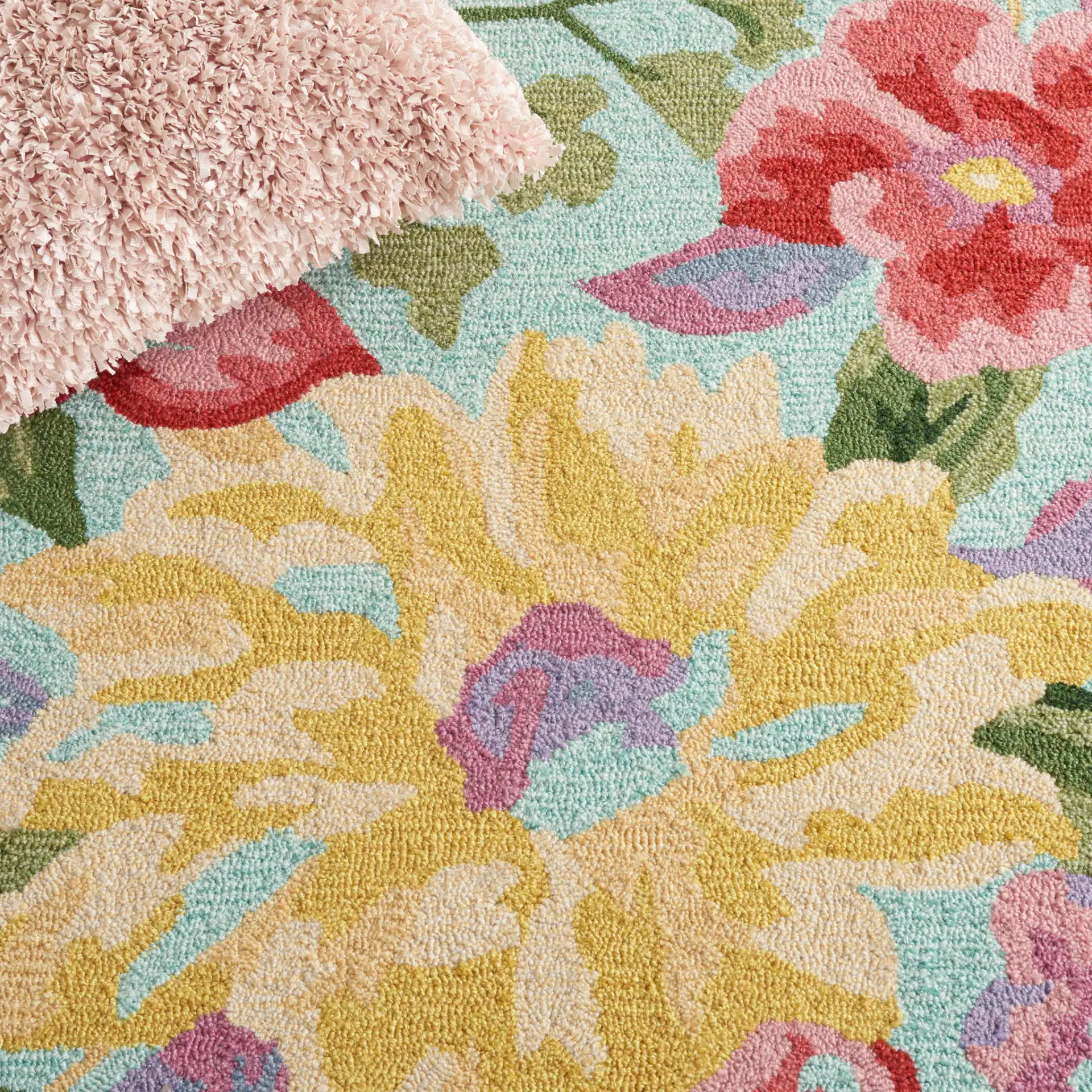 Easy Care Floral Bloom Hand-Tufted Rug in Blue / Pink in a styled room