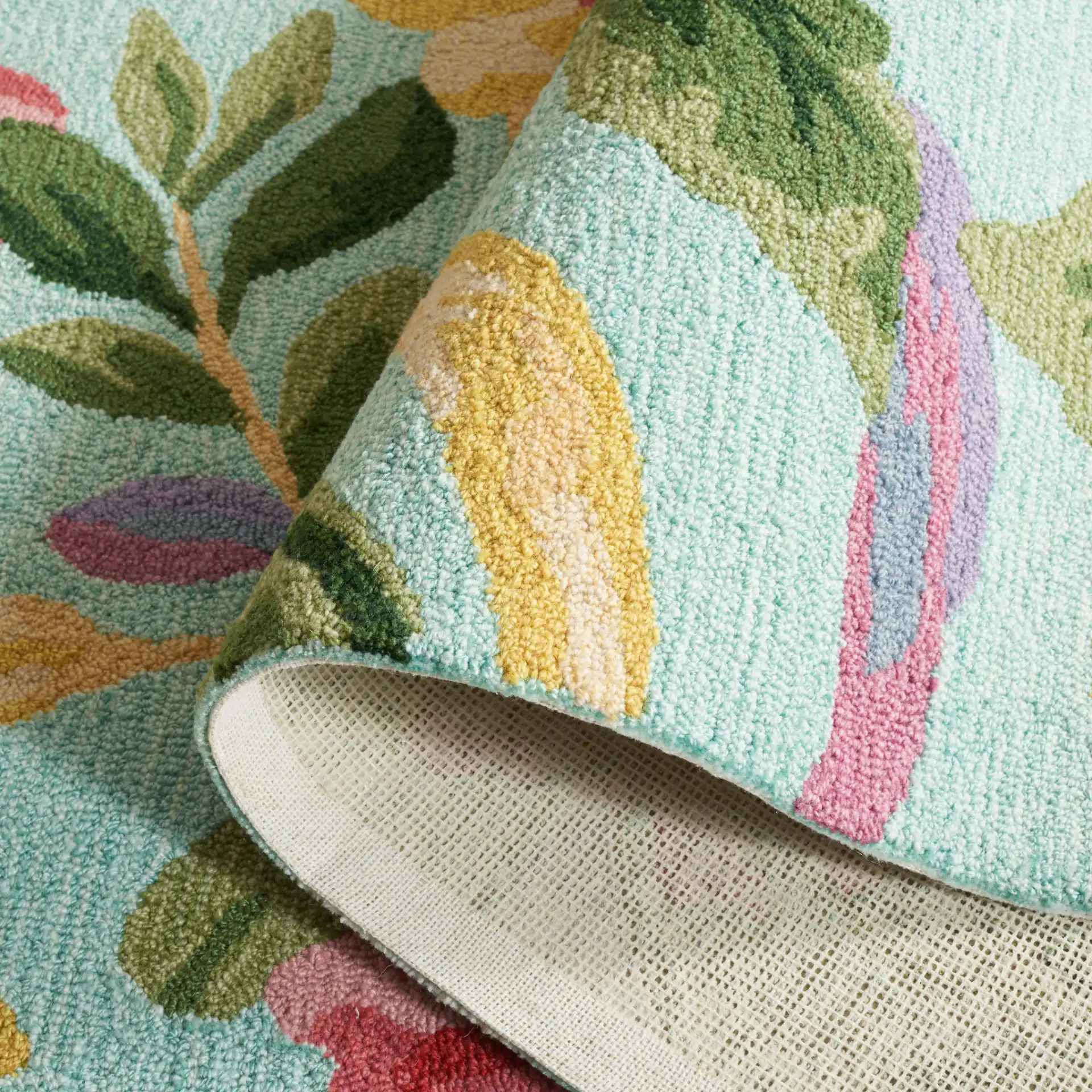 Easy Care Floral Bloom Hand-Tufted Rug in Blue / Pink in a styled room
