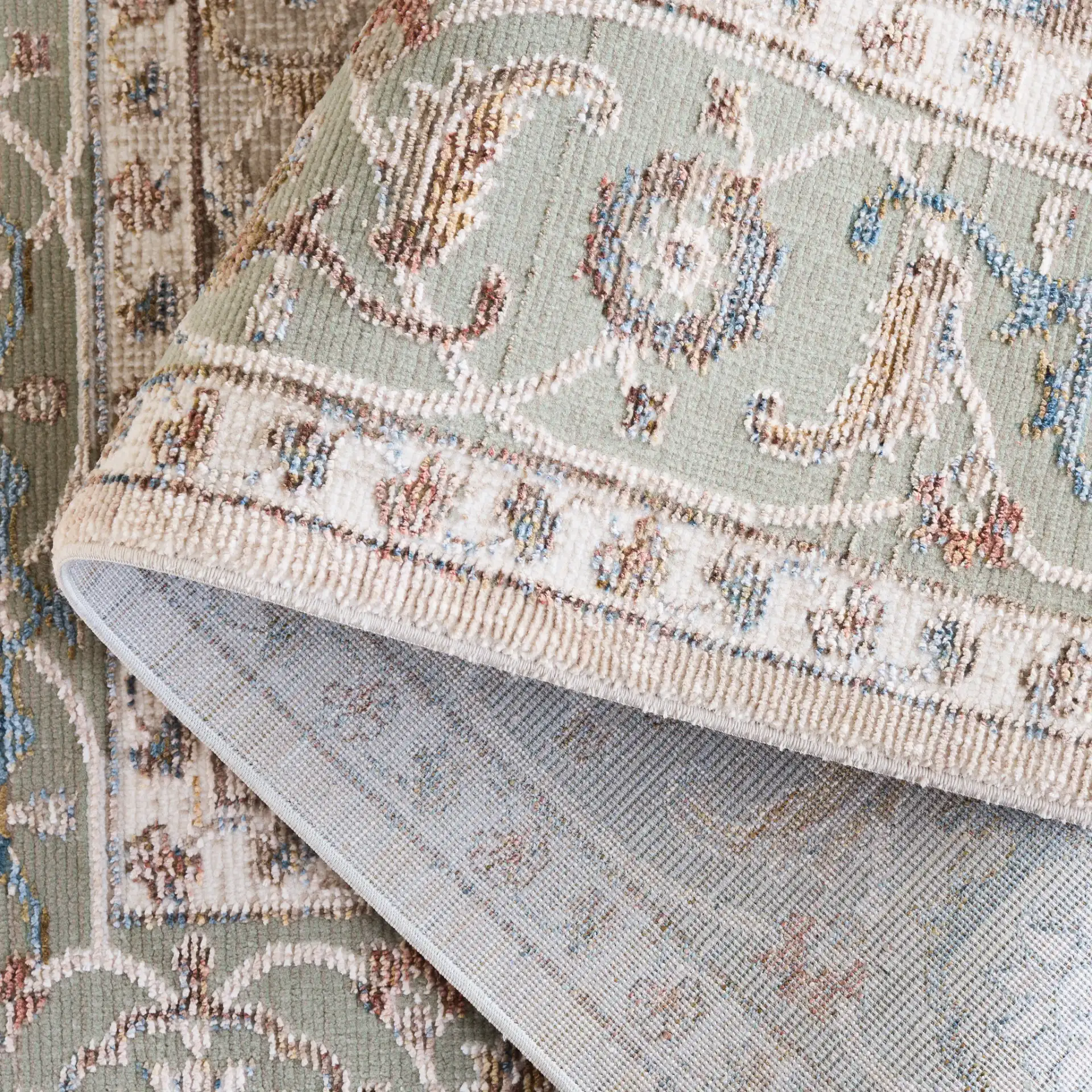 Ellwood Medallion Bordered Rug in Olive / Beige in a styled room