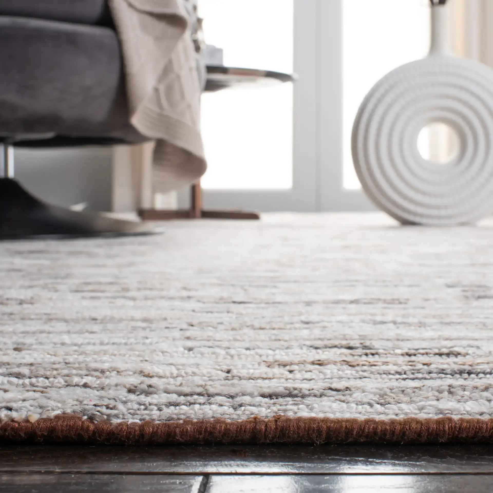 Elements Broken Stripe Loom-Knotted Bamboo Silk Rug in Brown / Light Gray in a styled room