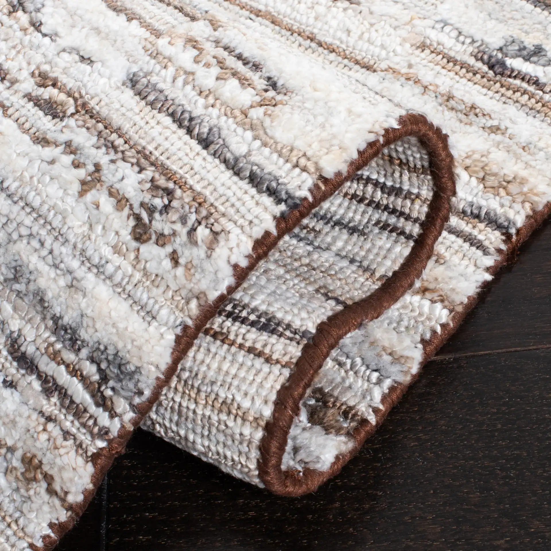 Elements Broken Stripe Loom-Knotted Bamboo Silk Rug in Brown / Light Gray in a styled room