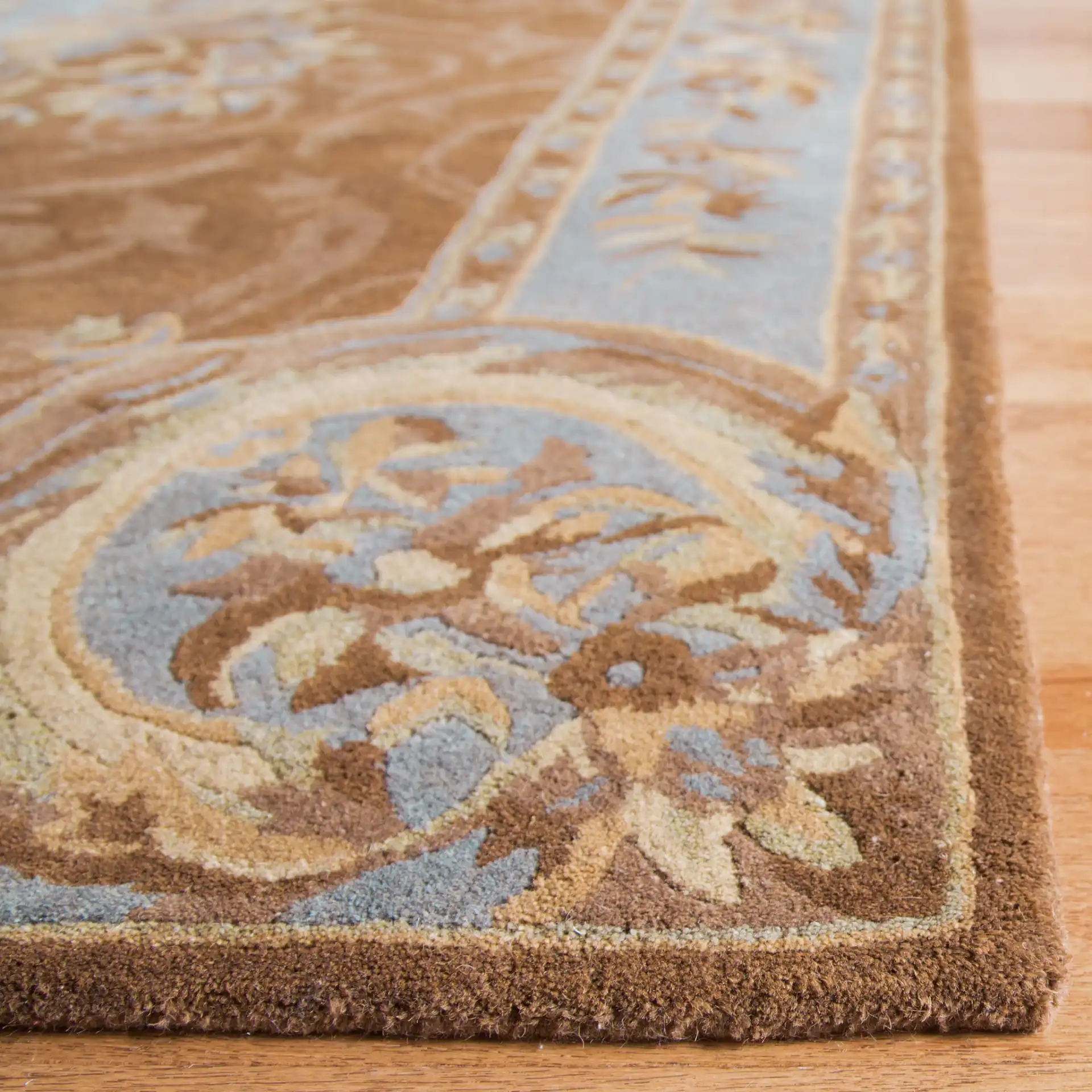 Empire Floral Medallion Hand-Tufted Wool Rug in Blue / Brown in a styled room
