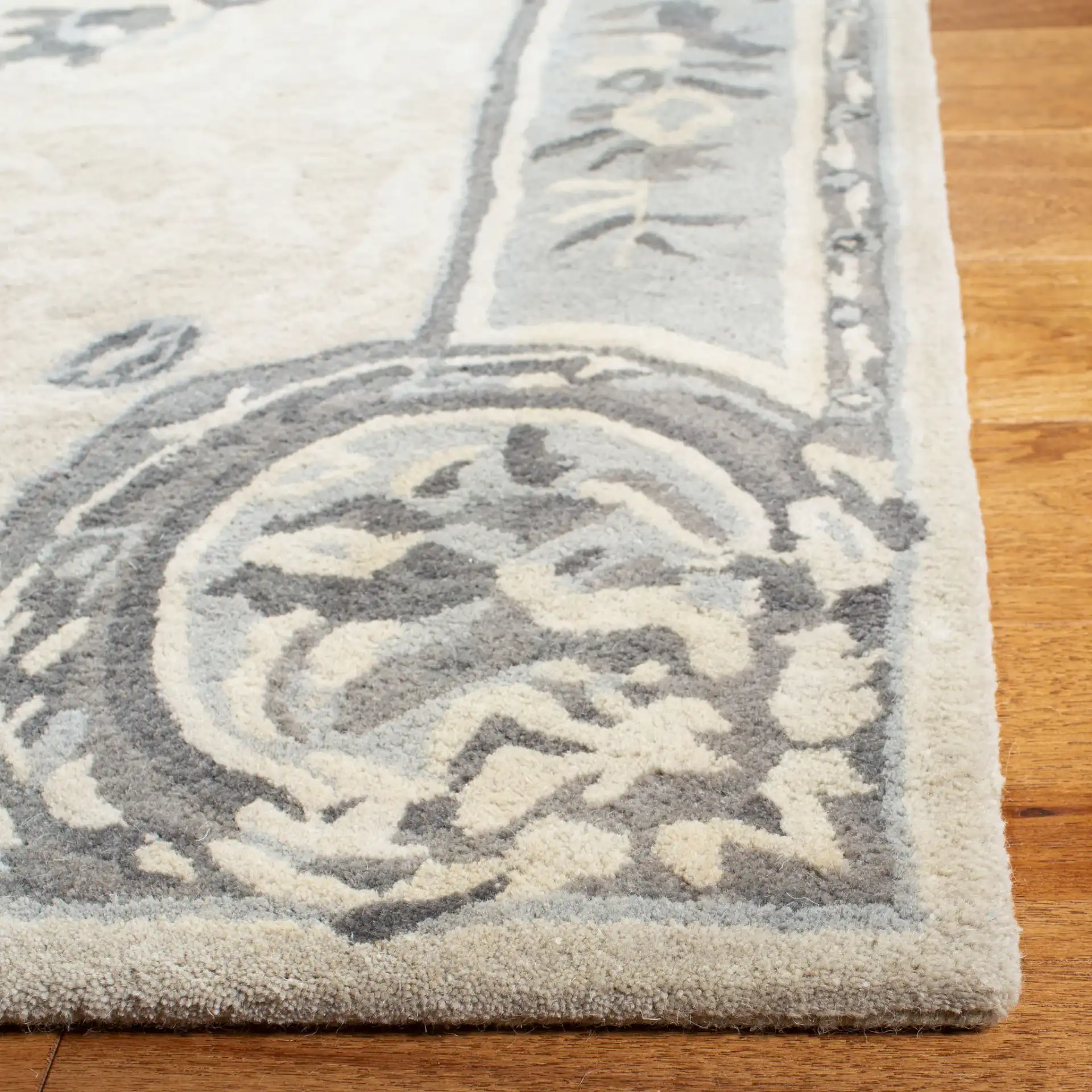 Empire Floral Medallion Hand-Tufted Wool Rug in Beige / Light Gray in a styled room